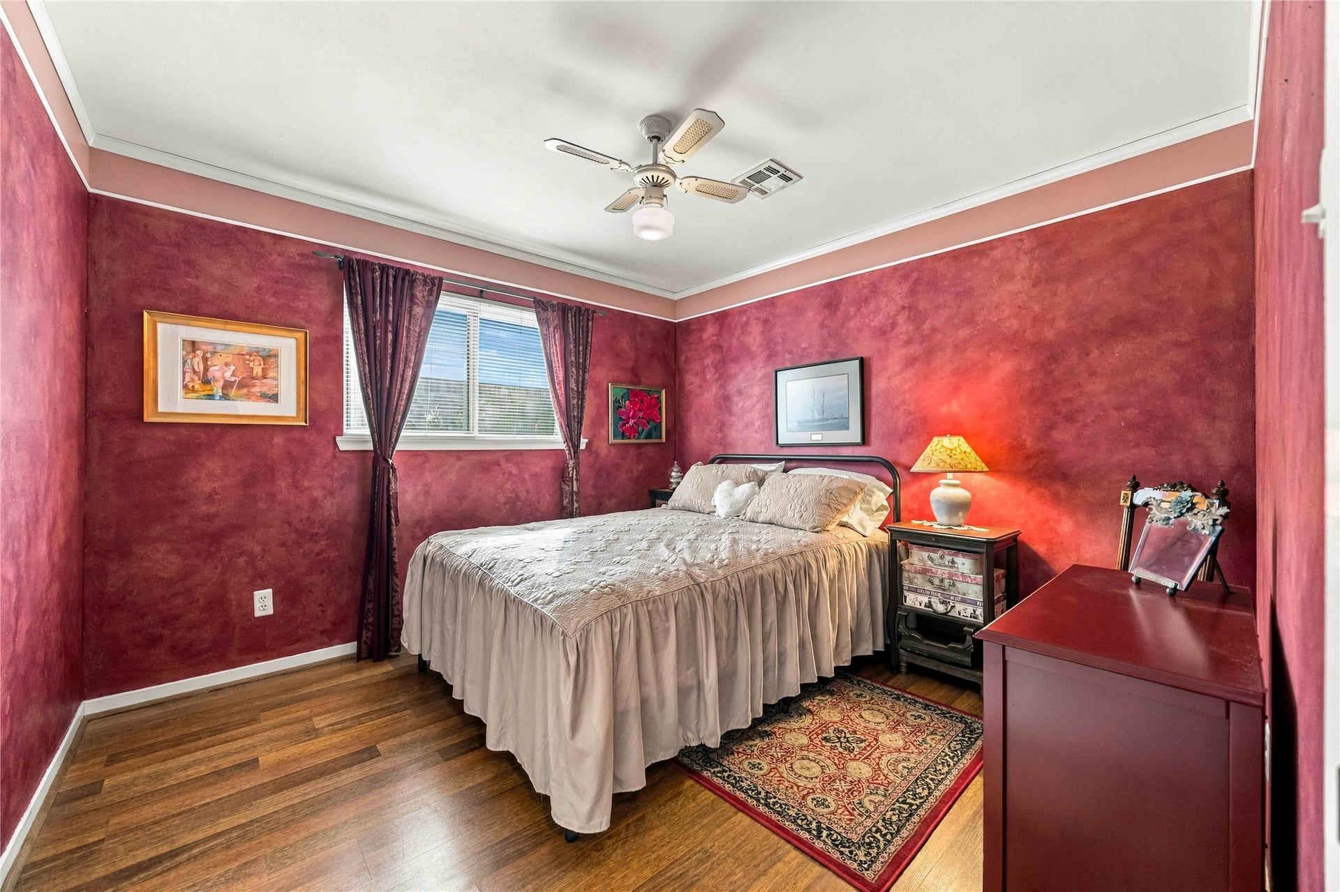 Secondary bedroom filled with natural light and complete with a spacious closet and ceiling fan.