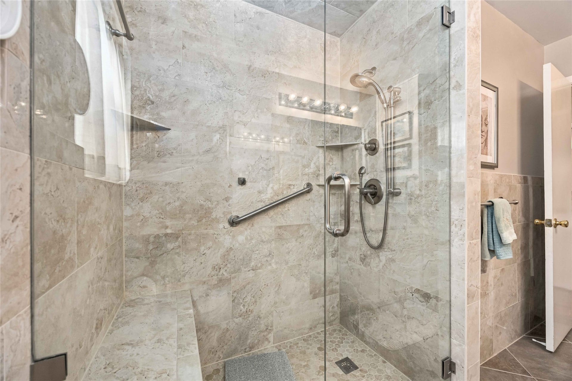 Updated frameless glass shower creates a clean, modern feel.
