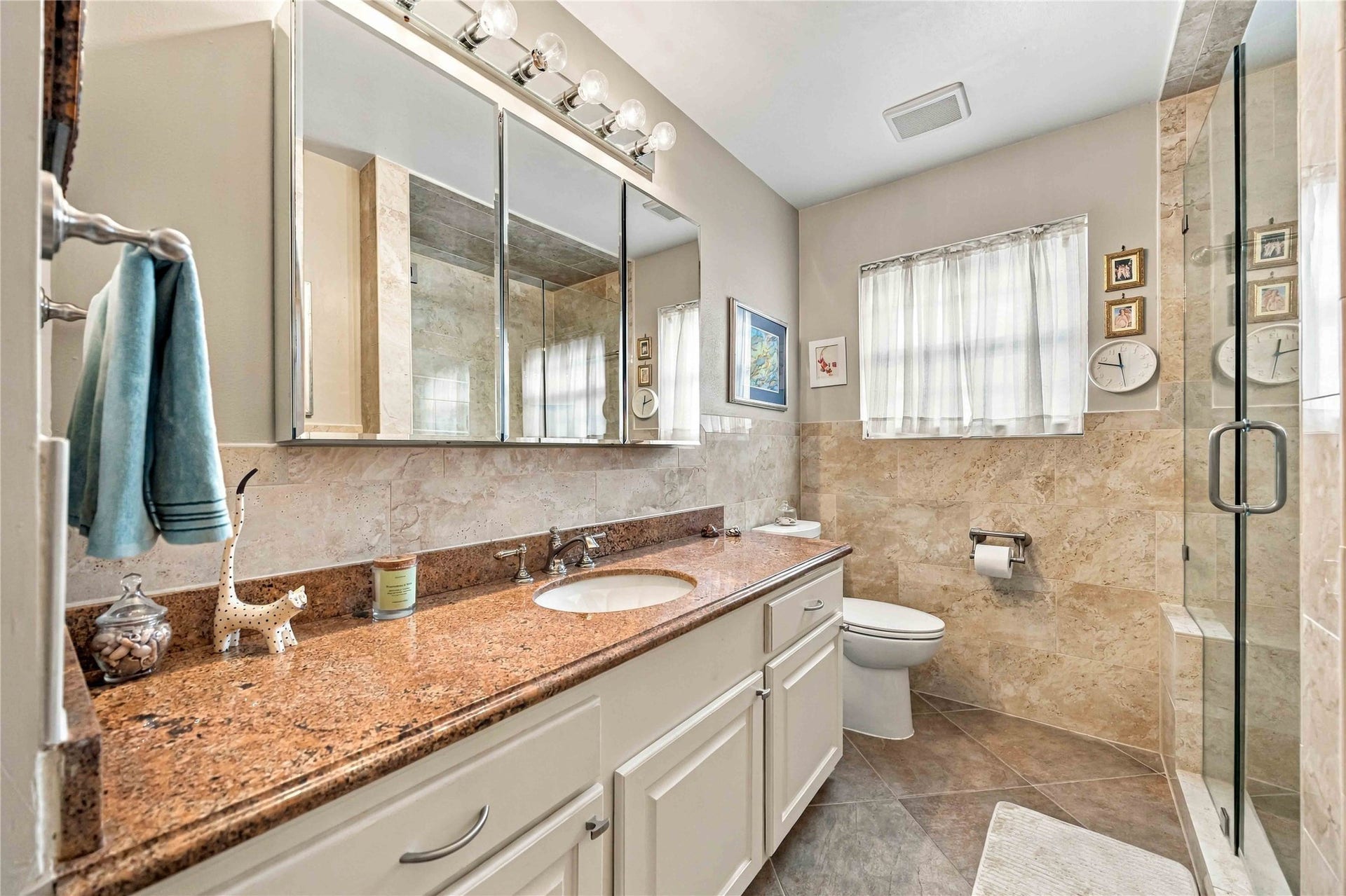 Secondary bath features a spacious vanity with plenty of counter space and storage.