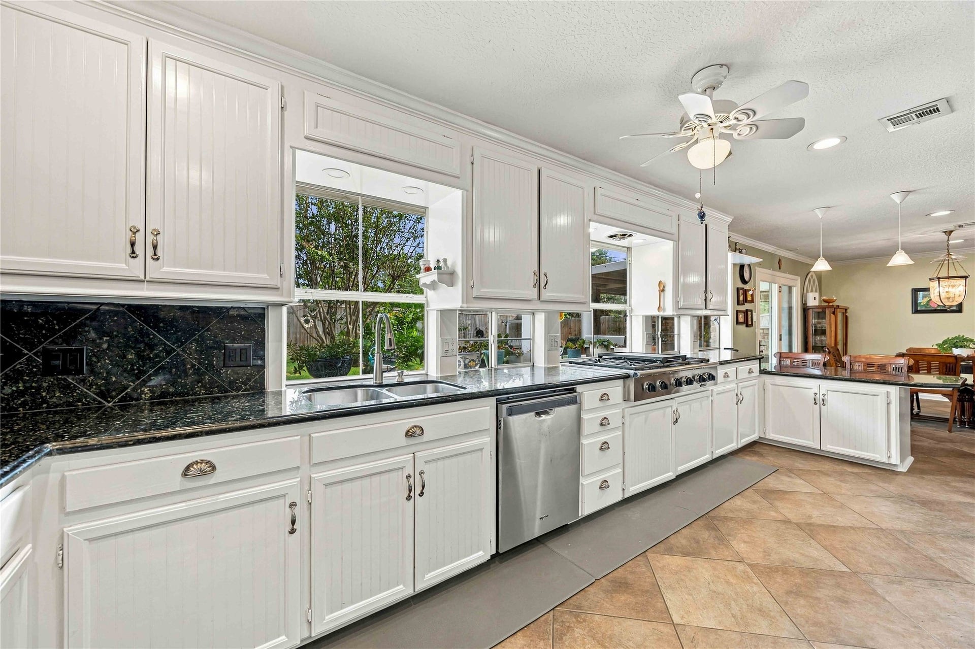Windows along the kitchen bring in abundant natural light and backyard views.