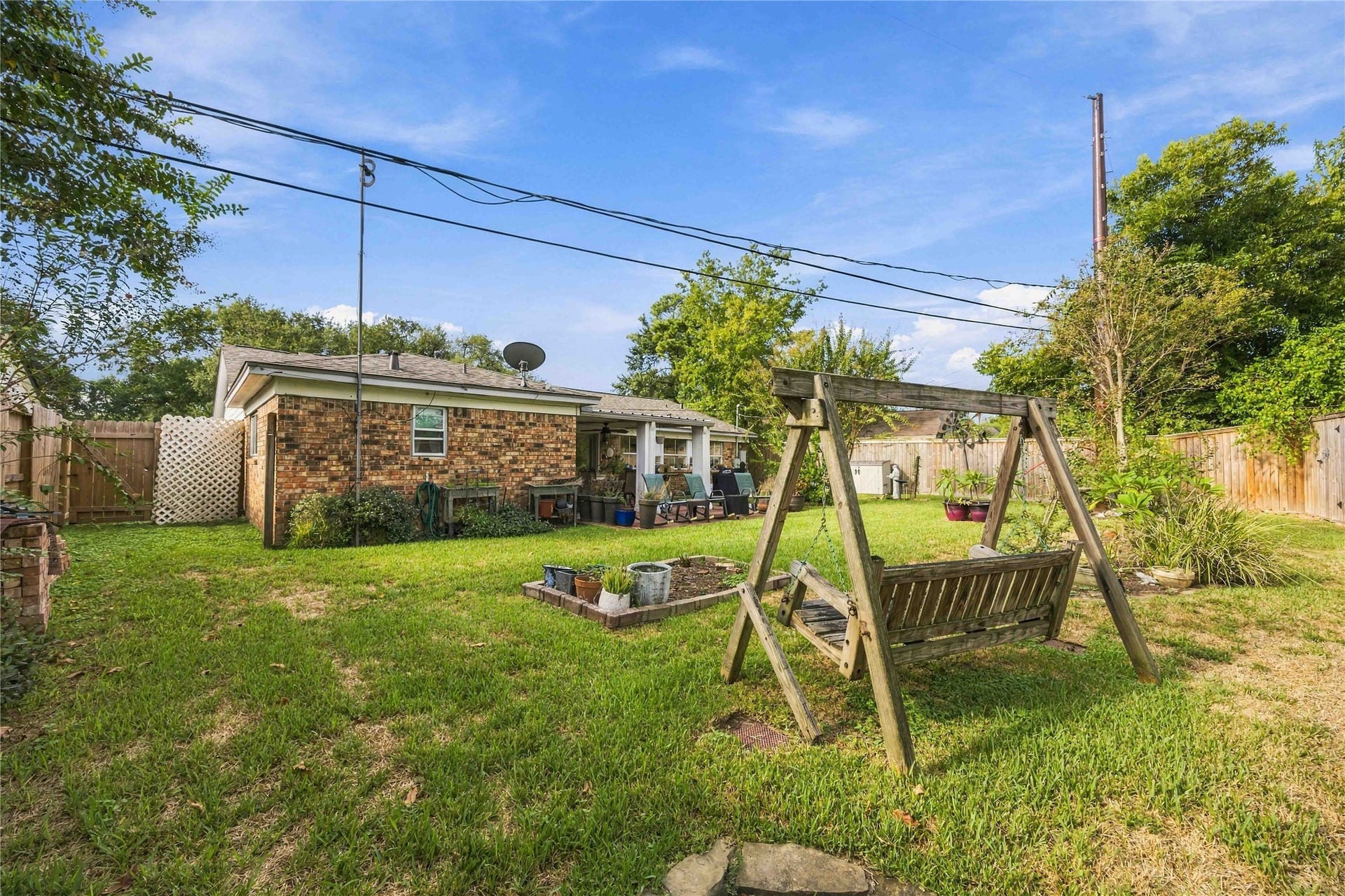 Beyond the patio, the expansive backyard offers plenty of room to enjoy the outdoors.
