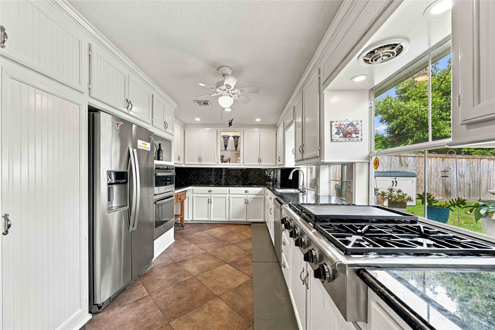 Bright, spacious kitchen surrounded by windows and natural light.