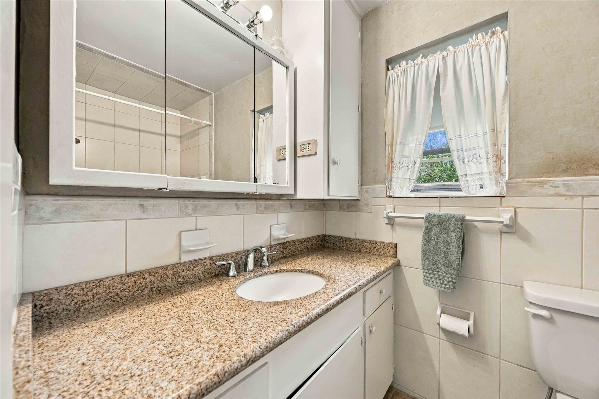 En-suite bath features an extended vanity with generous counter space and storage.