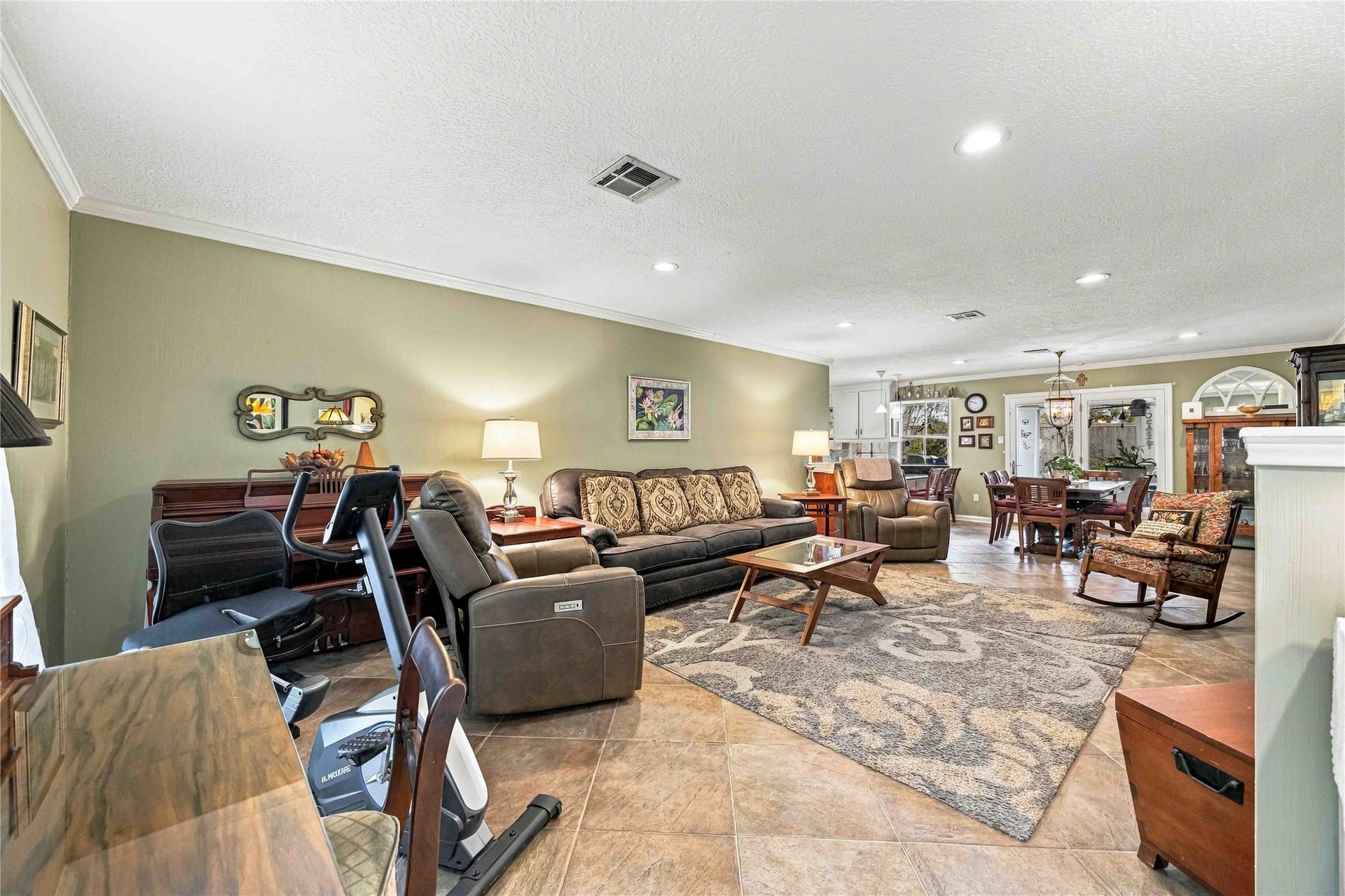 Step from the entry into the living room, with the dining area just beyond, creating an open and connected feel.