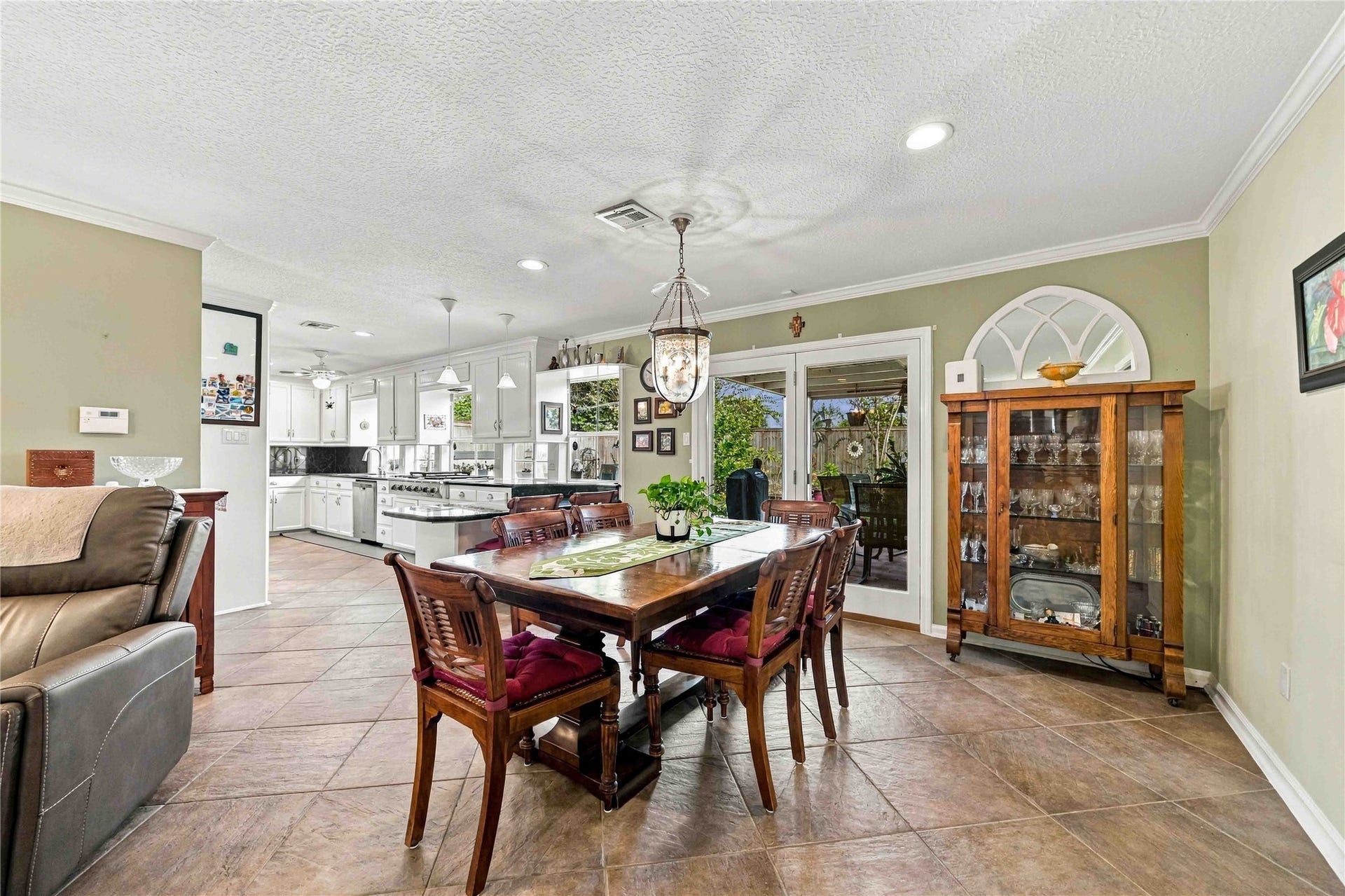 Spacious dining area opens to the covered back patio, extending the space for outdoor dining and entertaining.