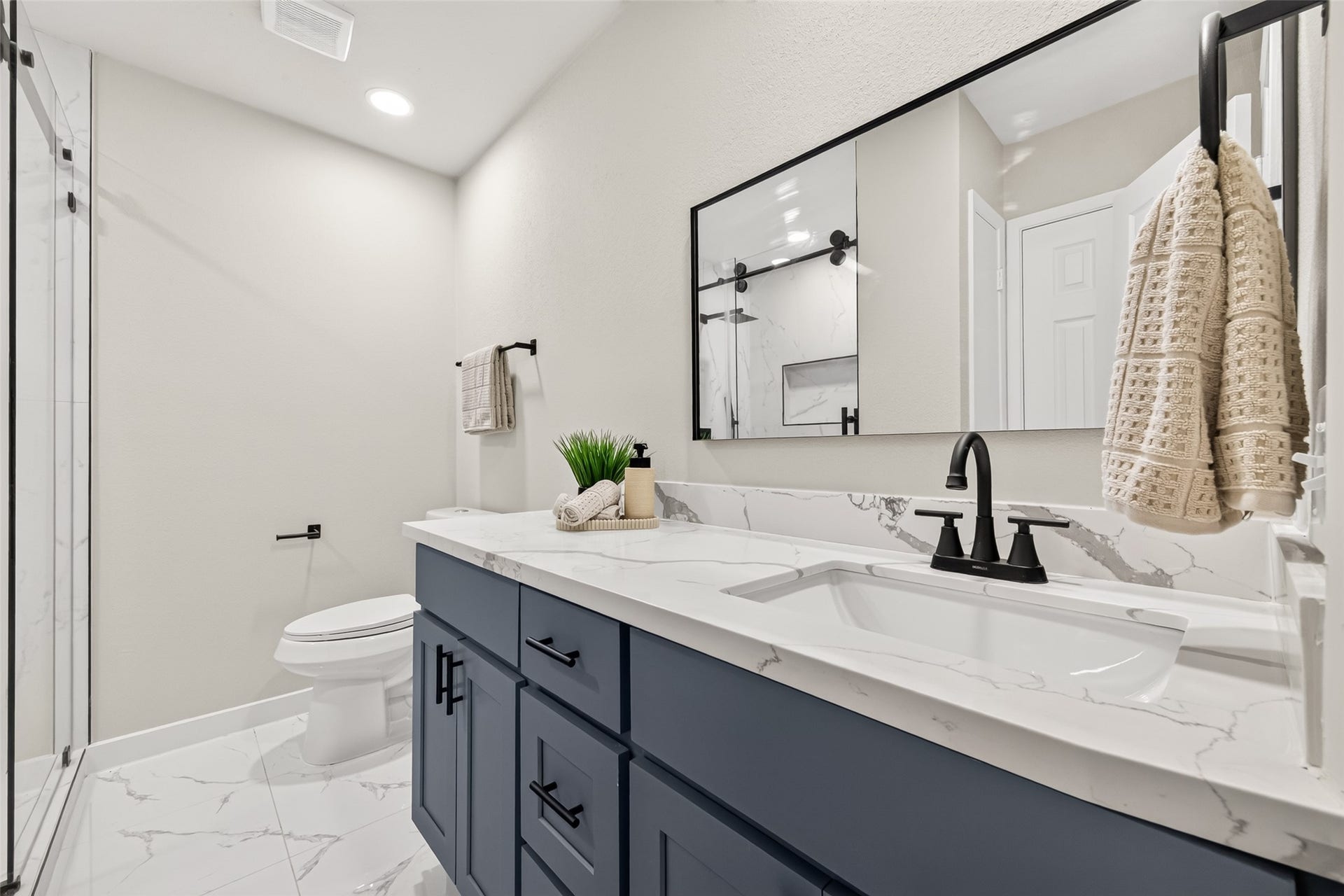 Spacious 2nd bath with all new modern finishes, floor to ceiling tiled standing shower