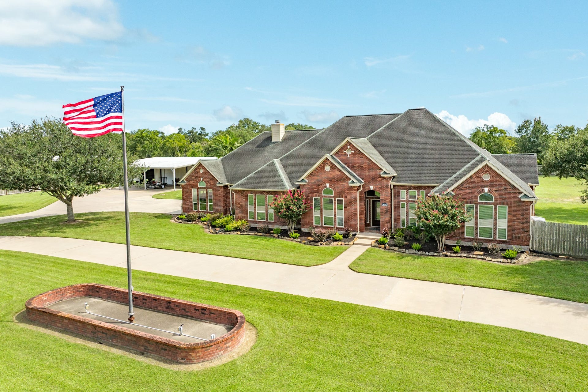 16337 County Road 171, Danbury, TX 77534 A stately exterior enhanced by flagpole lighting on an automatic timer.