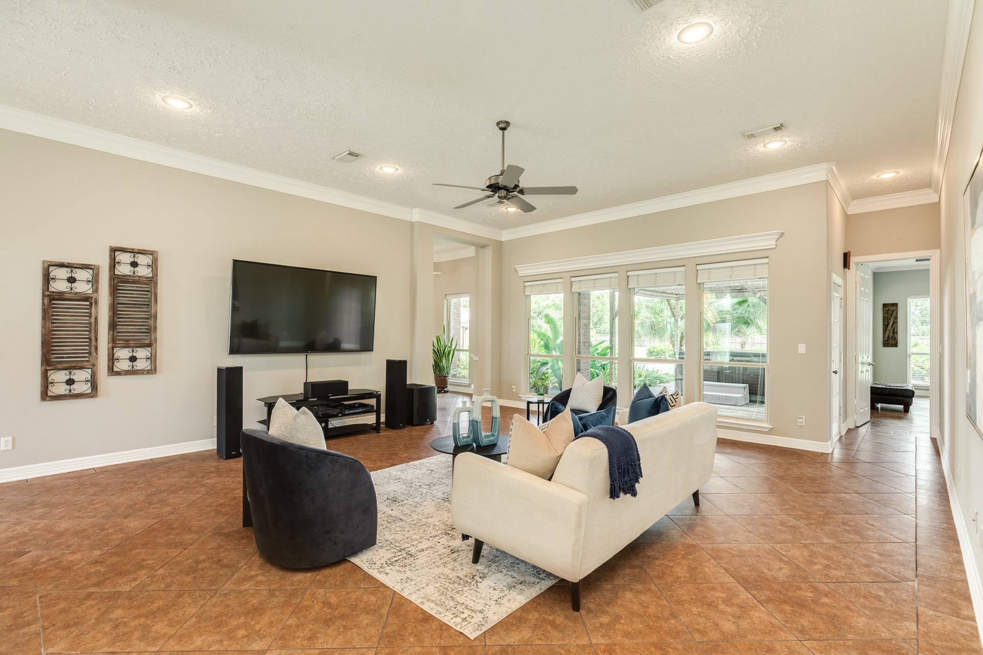 16337 County Road 171, Danbury, TX 77534 Another view of the spacious front living area, showcasing its high ceilings, crown molding, abundant natural light, and generous layout with views towards the backyard.