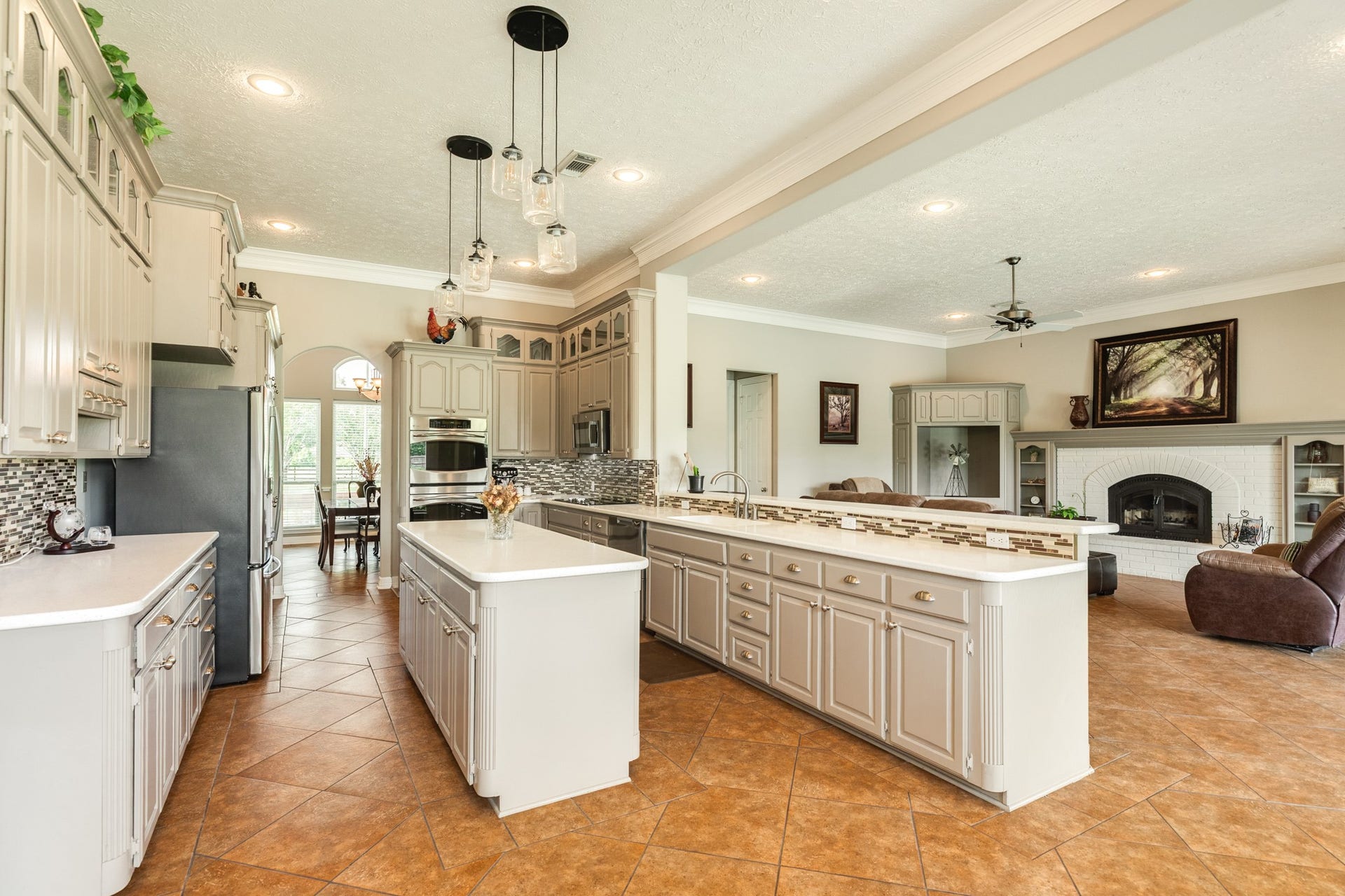 16337 County Road 171, Danbury, TX 77534 the spacious kitchen opens seamlessly to the living area and features abundant cabinetry, generous counter space, a large island, and additional breakfast bar seating.