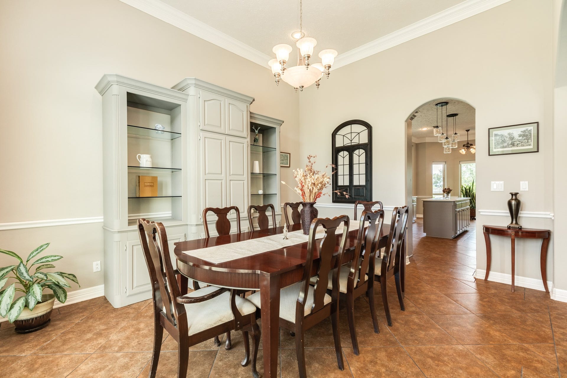 16337 County Road 171, Danbury, TX 77534 The formal dining area offers an elegant setting for gatherings, featuring high ceilings, crown molding, and beautiful built-in cabinetry for added character and display.