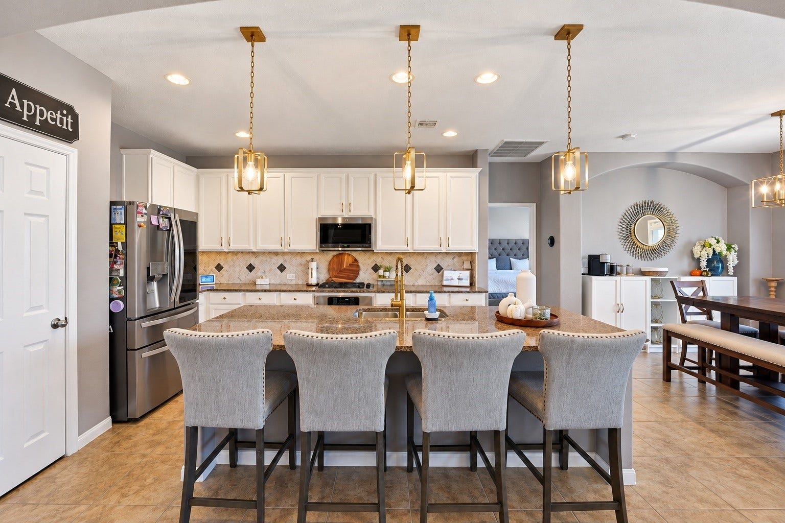 A chef's delight, this kitchen offers luxurious granite counters, 42" cabinets w/modern hardware, tile backsplash, SS appliances, 5-burner gas cooktop & massive eat-in island w/beautiful pendant lights!