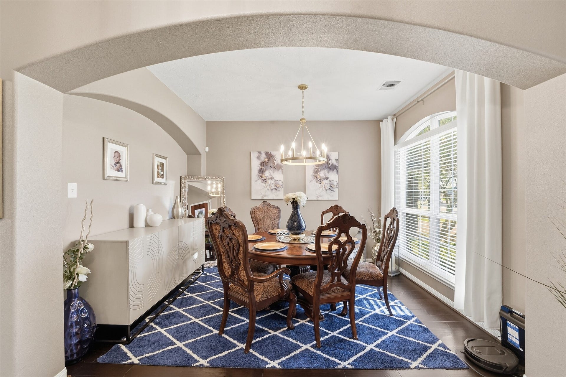 Elegant Formal Dining Room, beautiful chandelier, elegant arches and gorgeous wood floor