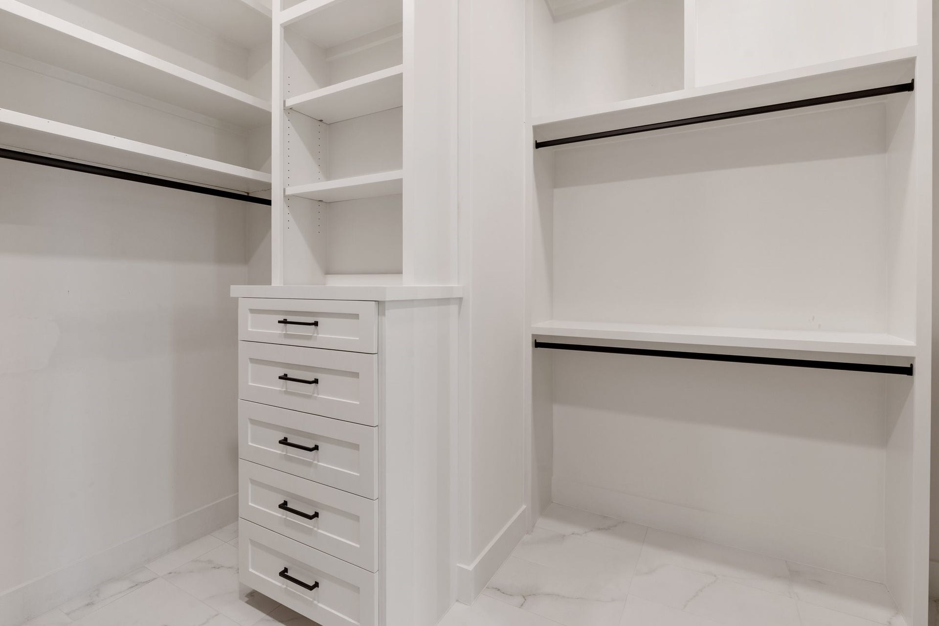 A peek into the large walk-in closet with "his and hers" dressers and hidden storage.
