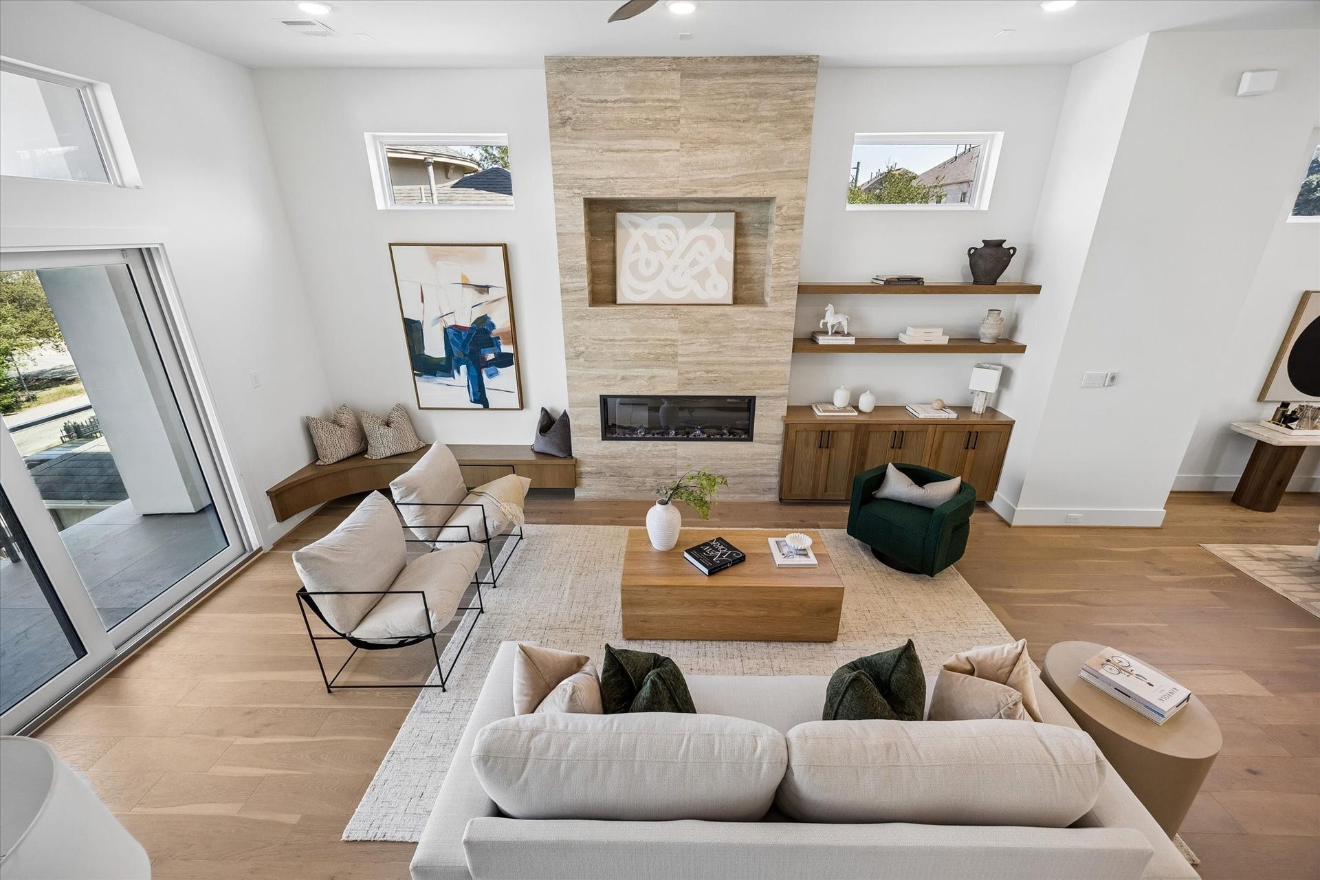 A look down towards the living room with Ply Gym 3-panel sliding doors opening to a large balcony. Fabulous indoor/outdoor living!