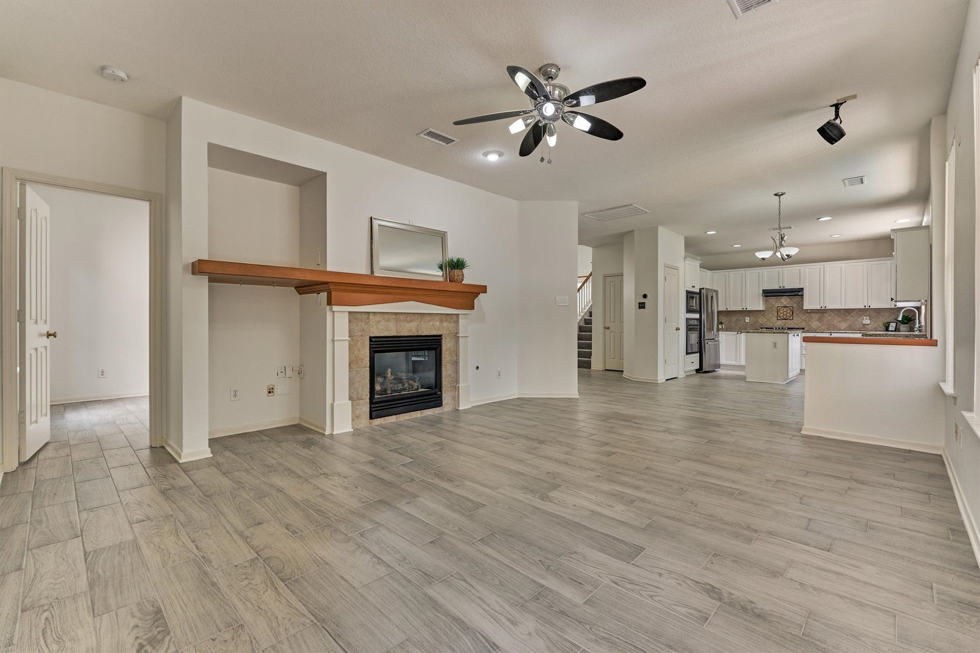 11 Vinca Trail, The Woodlands, TX 77382 This view shows the family room leading to the kitchen and home office tucked away to the left.