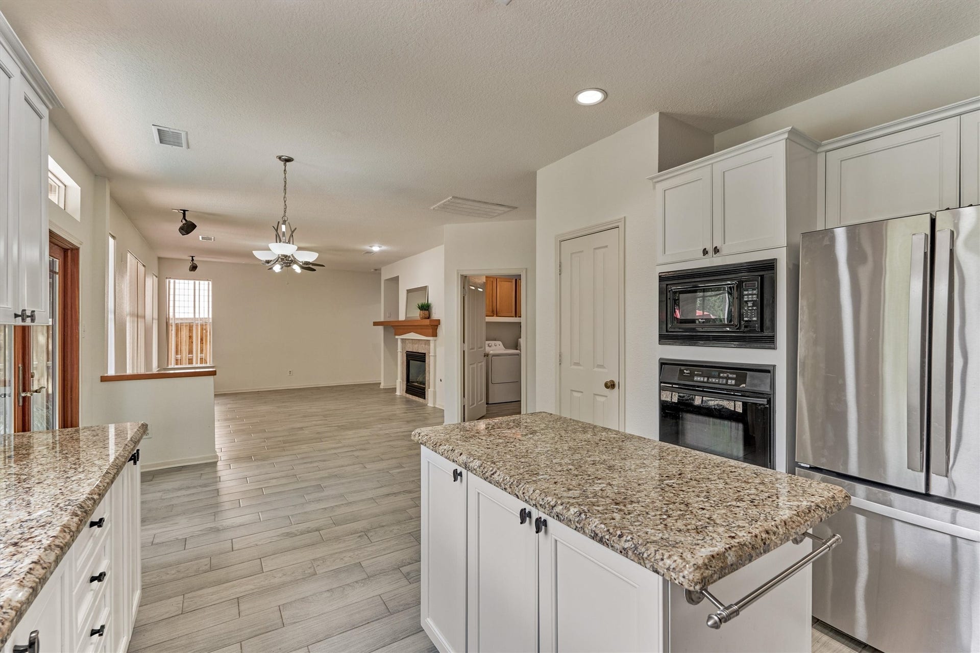 11 Vinca Trail, The Woodlands, TX 77382 The kitchen flows easily into the family area. The fridge also stays with the home!