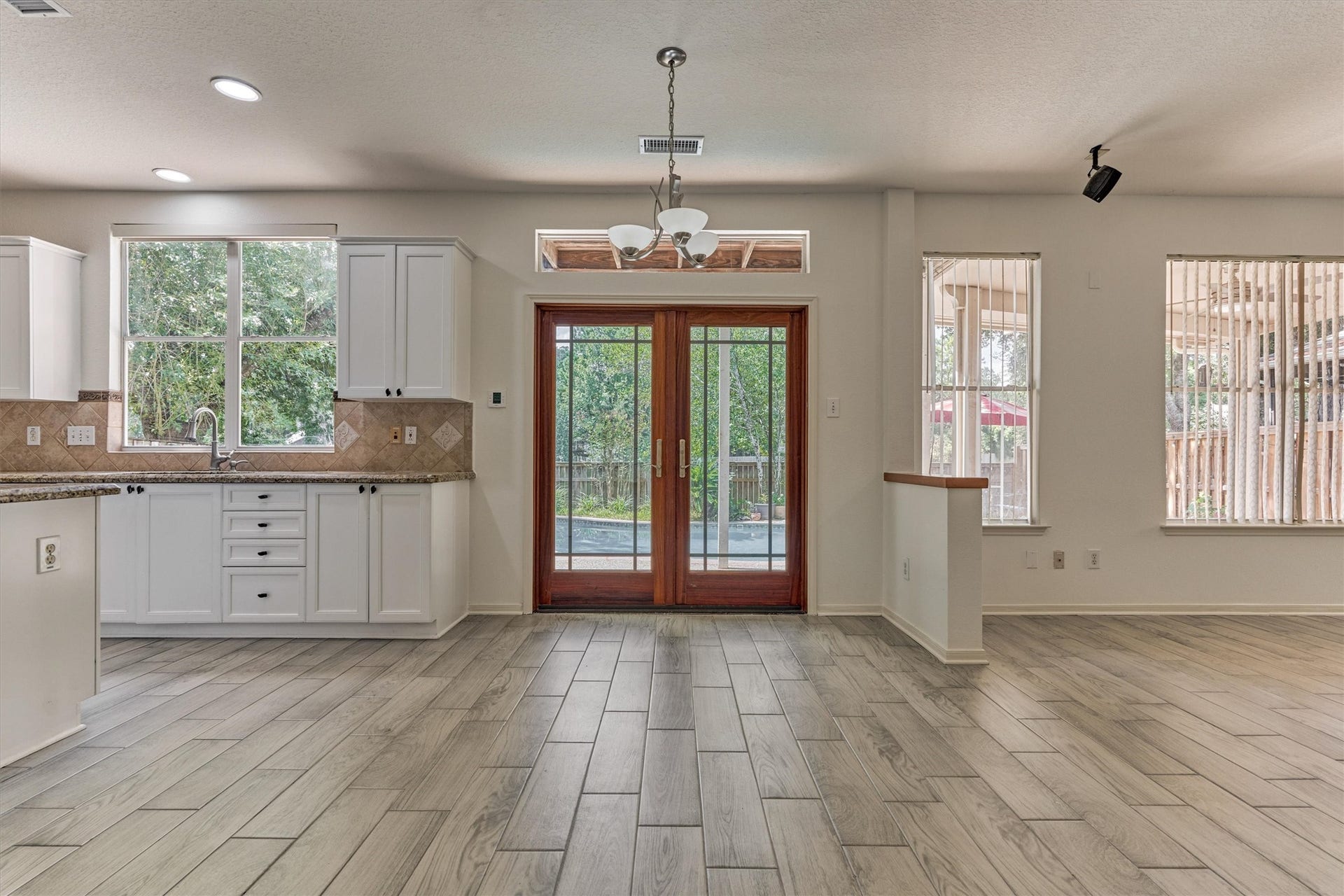 11 Vinca Trail, The Woodlands, TX 77382 This shows the space you have for the breakfast area and how open the the home is. Beautiful glass doors lead you out to the backyard.