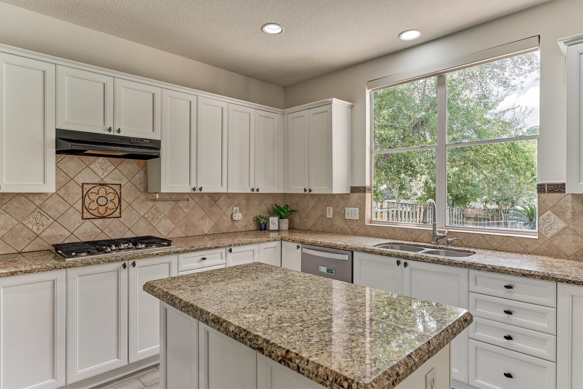 11 Vinca Trail, The Woodlands, TX 77382 The bright kitchen with a lovely window over the kitchen sink area.