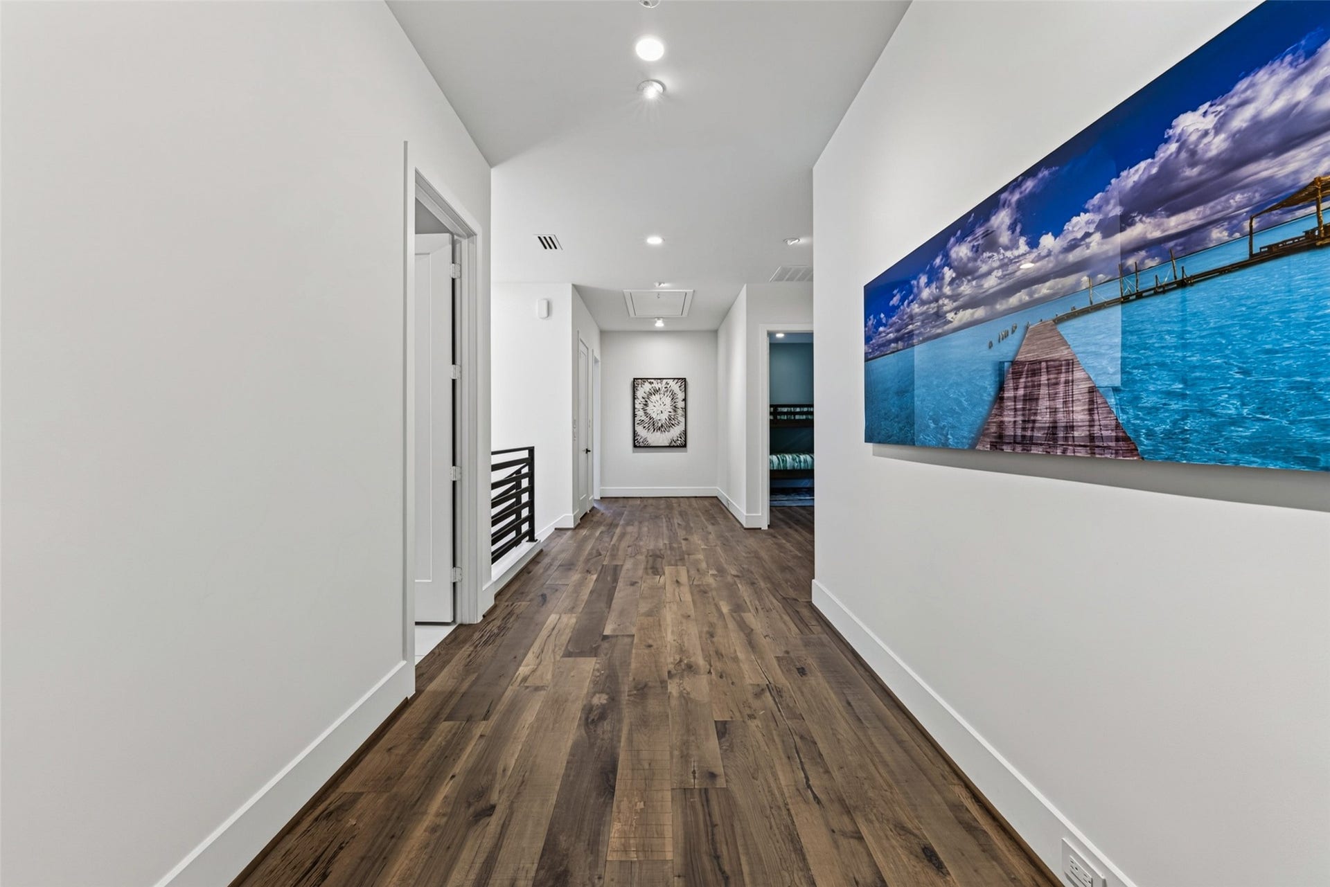 1716 Driscoll Street, Houston, TX 77019 The secondary bedrooms are located down the hall from the primary. Art lighting has been added to feature your collection.
