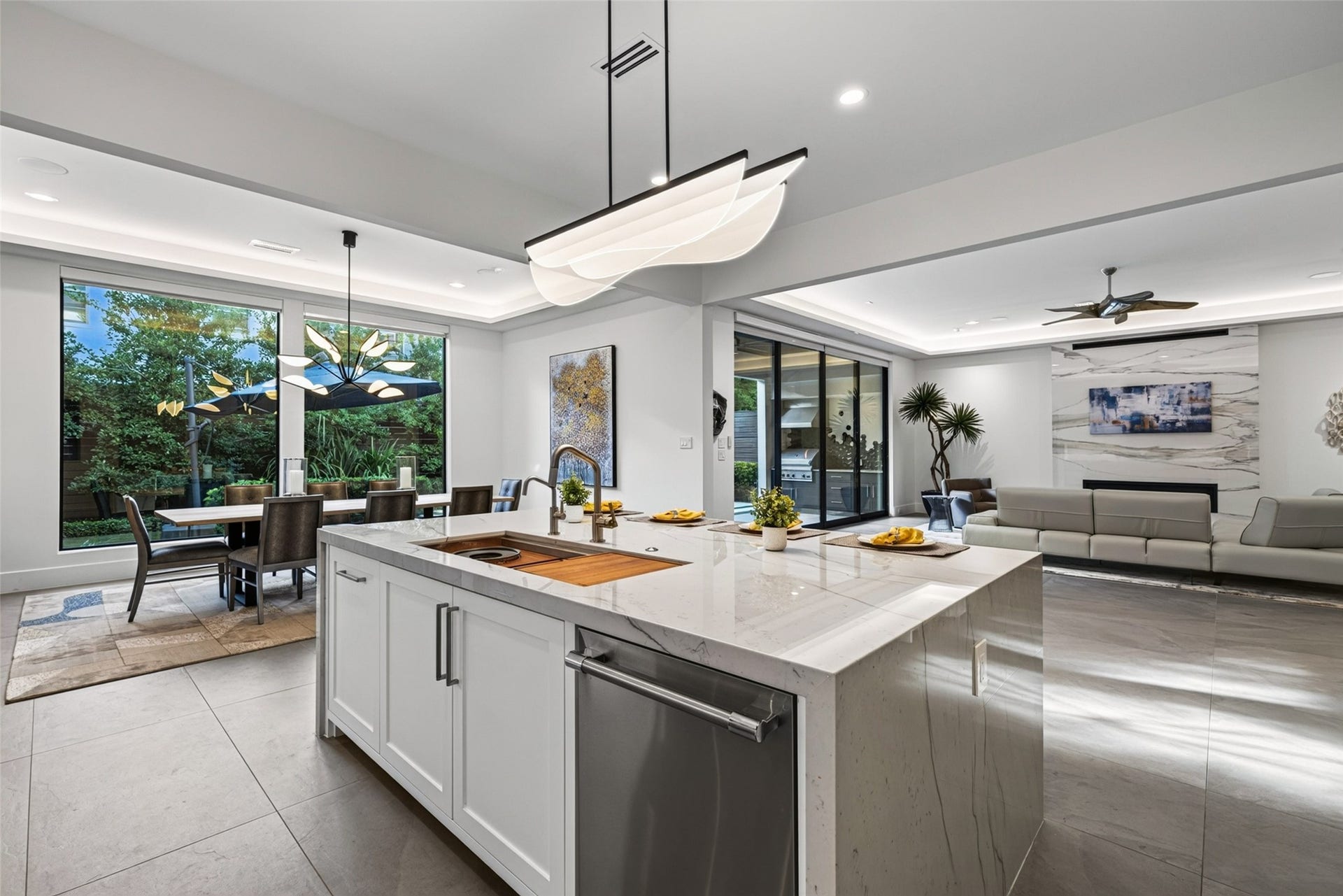 1716 Driscoll Street, Houston, TX 77019 A double waterfall edge quartzite island perfectly compliments the Italian porcelain flooring and floor to cieling slab in the living room.