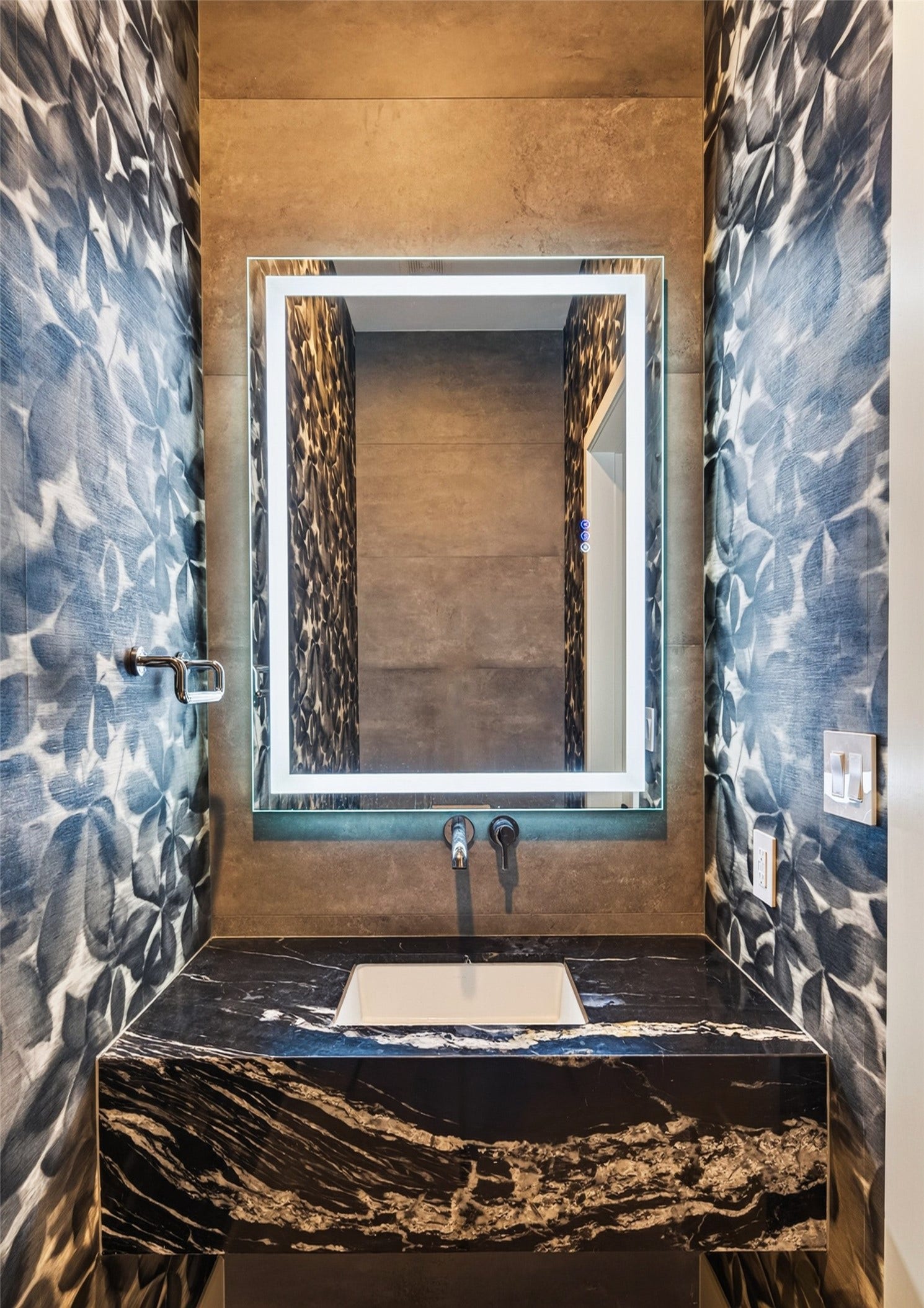 1716 Driscoll Street, Houston, TX 77019 Every bathroom in the home features anti-fog lit mirrors adding an additional element of sophistication. This is the powder room on the first floor.