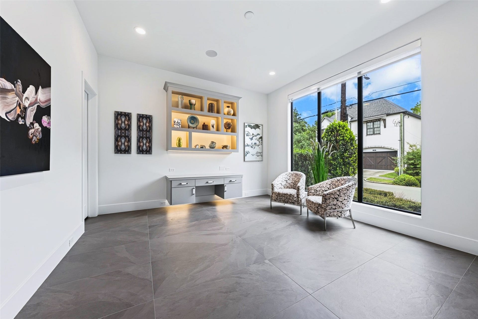 1716 Driscoll Street, Houston, TX 77019 A home office is located on the first floor to the right when you enter the front door. The custom floating desk and shelving was added in 2024. There is a huge closet beyond the door to the left that houses the home automation hub.