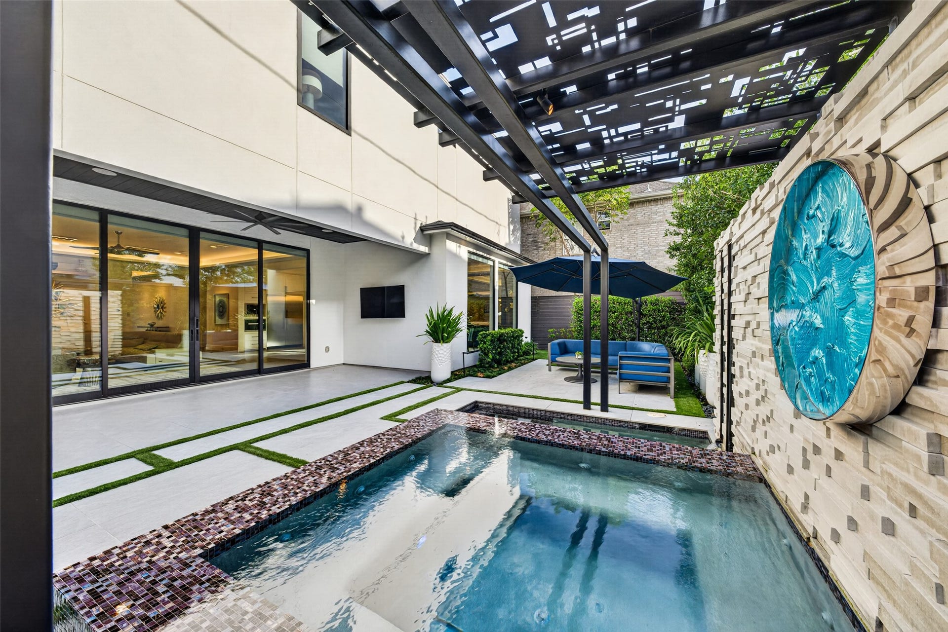 1716 Driscoll Street, Houston, TX 77019 Custom outdoor tile and stonework, an landscape irrigation system and turf inlay make the outdoor space easy to maintain.
