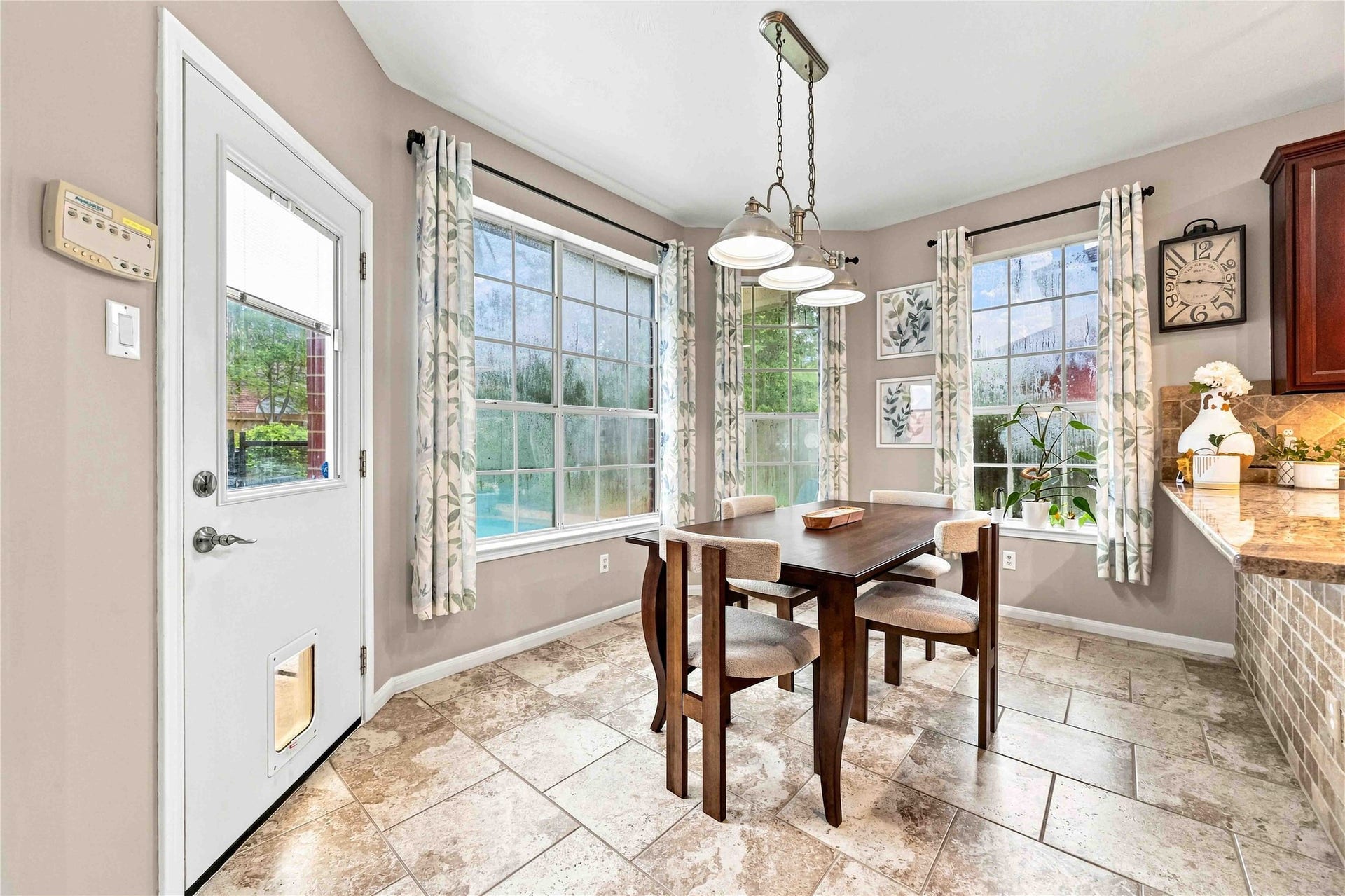 4118 Laurette Court, Sugar Land, TX 77479 Bright and inviting dining area with large windows, offering a view of the beautiful backyard.
