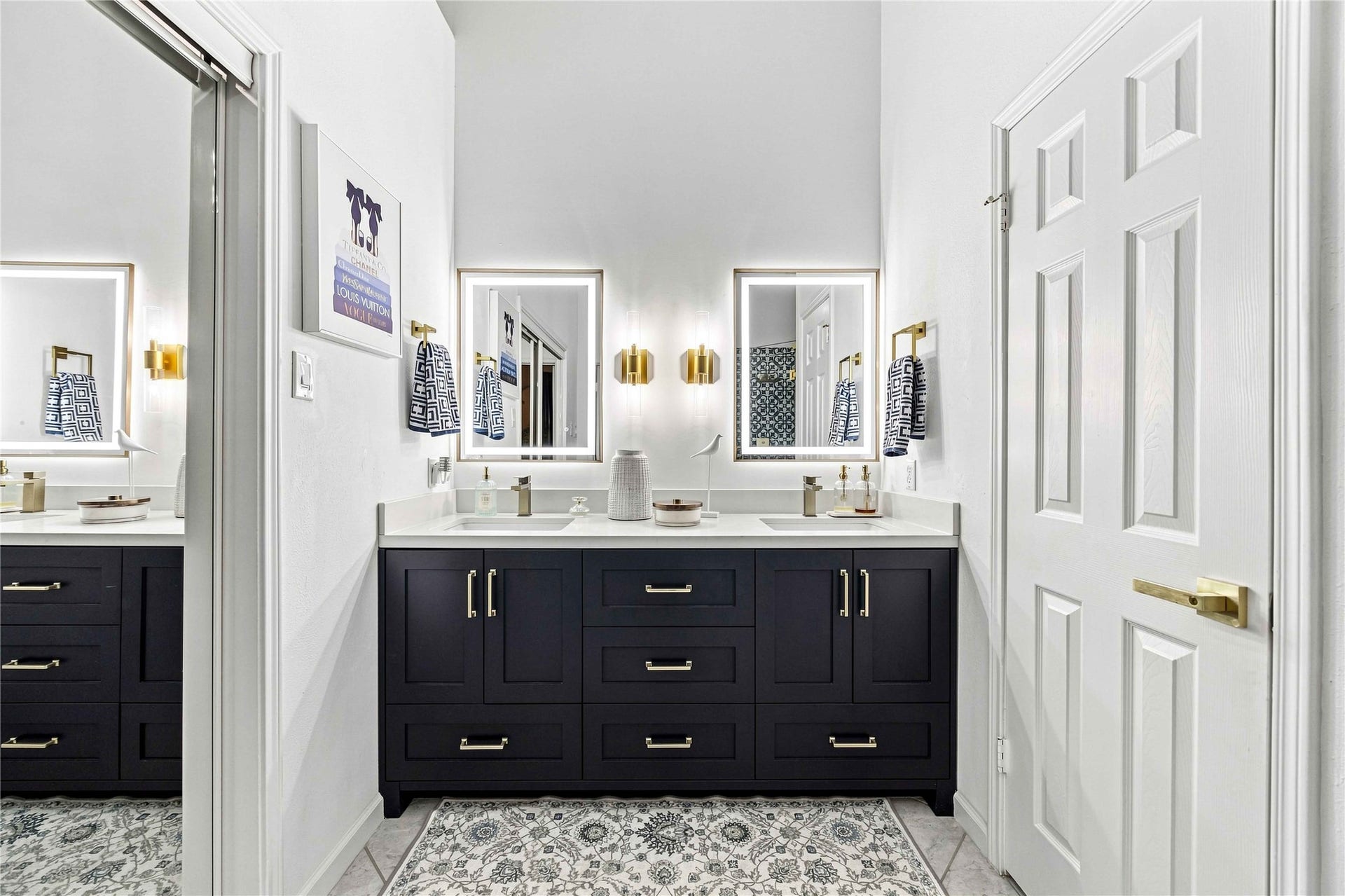 4118 Laurette Court, Sugar Land, TX 77479 A high-end primary bathroom featuring custom cabinetry, designer fixtures, and bold contemporary tilework.