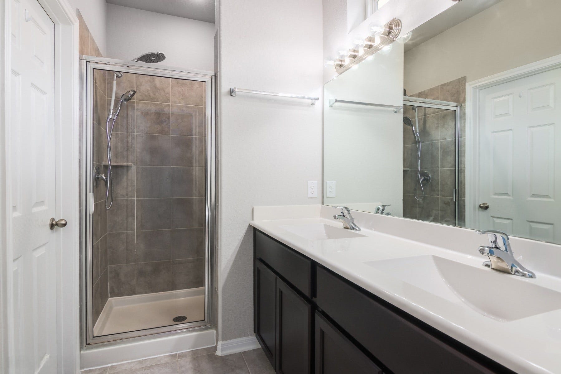 517 N 6th Street, La Porte, TX 77571 Beautifully appointed bathroom featuring a dual-sink vanity, generous counter space, and a glass-enclosed shower.