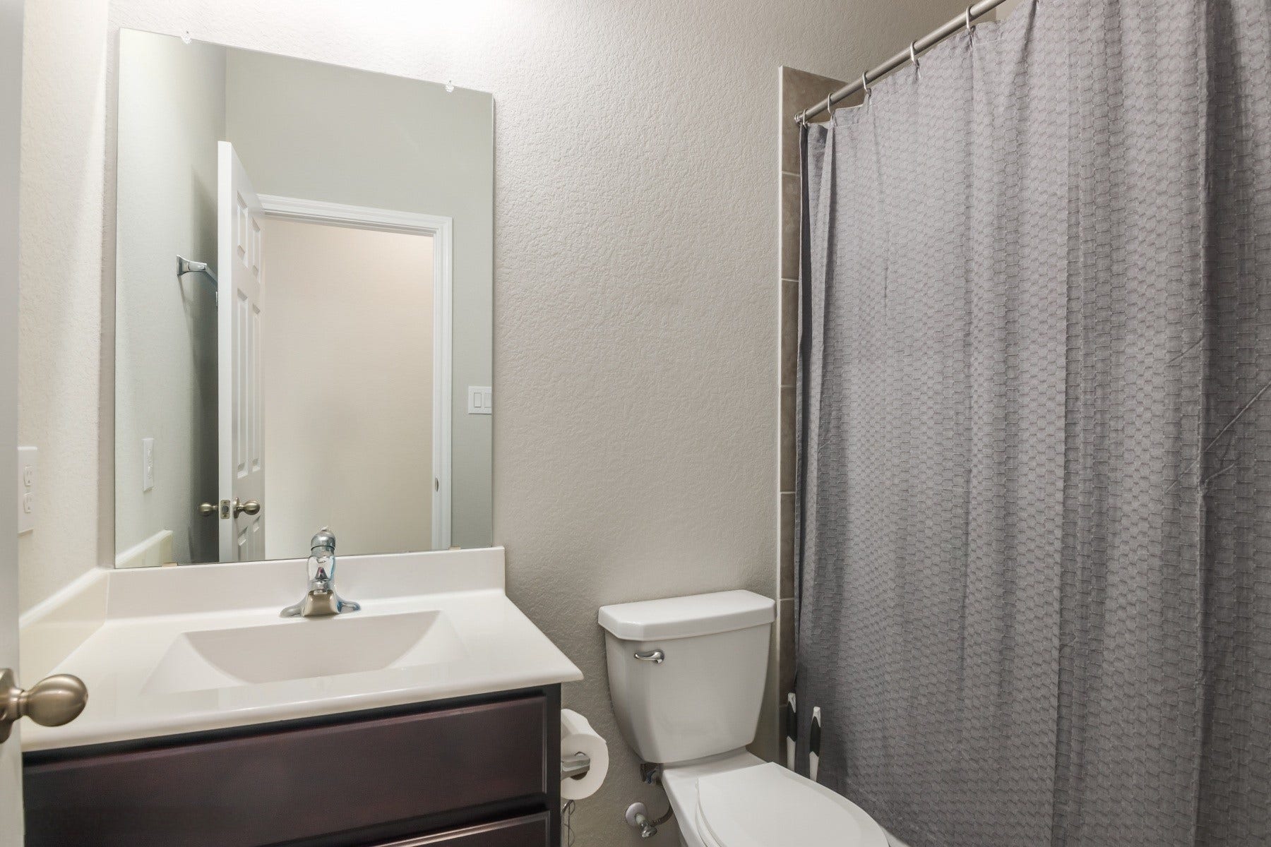517 N 6th Street, La Porte, TX 77571 Clean, contemporary bathroom featuring a sleek vanity and shower-tub combination.