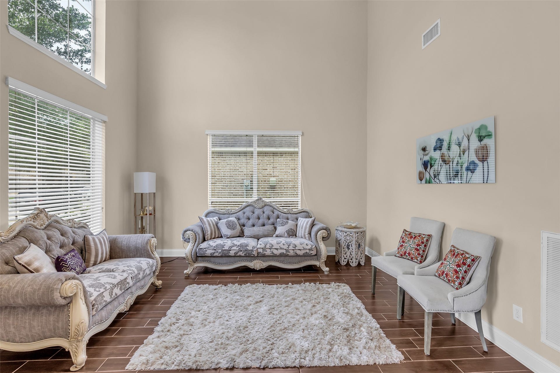 3314 Sussex Way, Friendswood, TX 77546 The living room is filled with natural light from the expansive windows. Its open-to-above design creates an airy and spacious atmosphere.