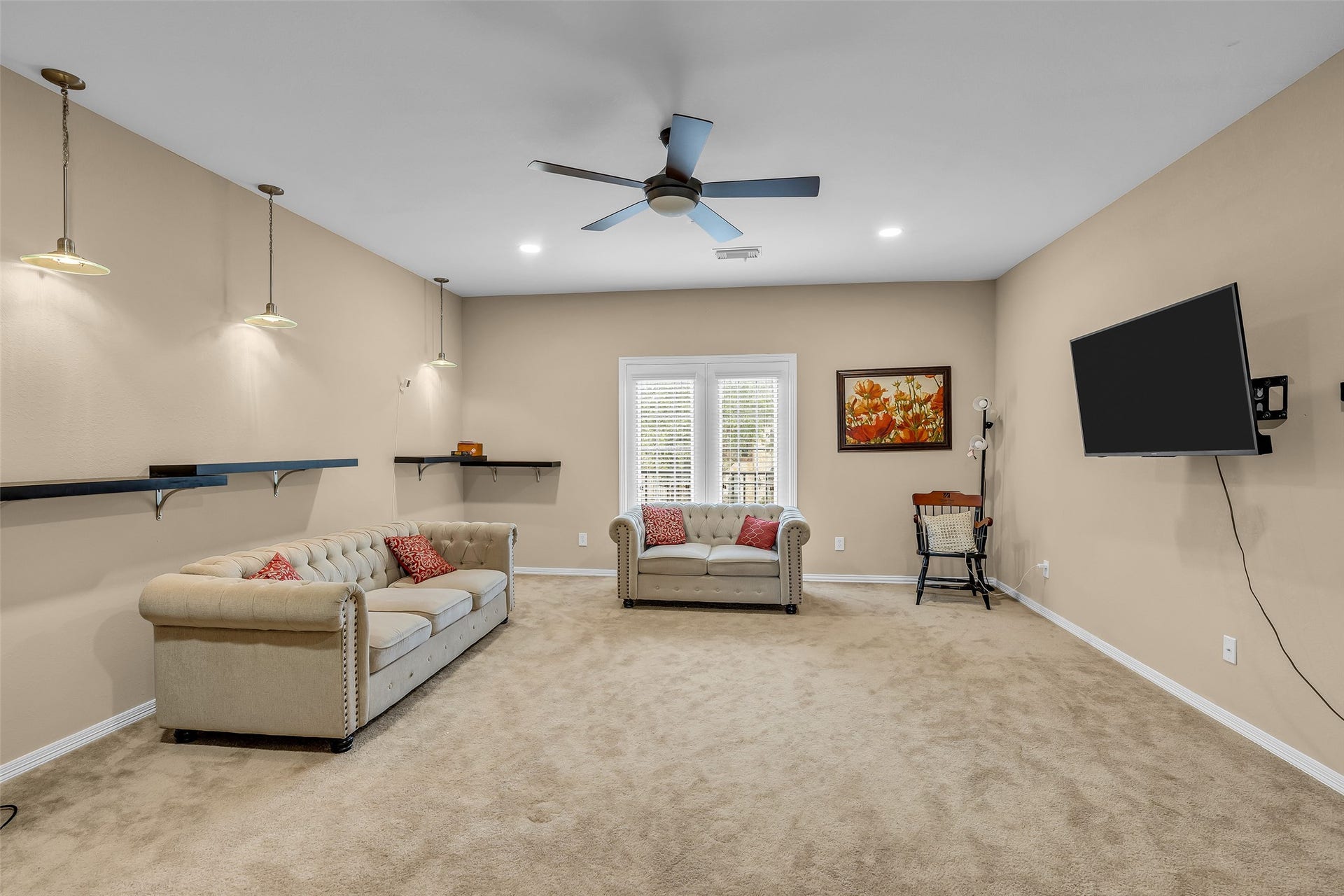 3314 Sussex Way, Friendswood, TX 77546 Second-floor sitting room with carpeted flooring, offering a comfortable space to relax and unwind after a long day.