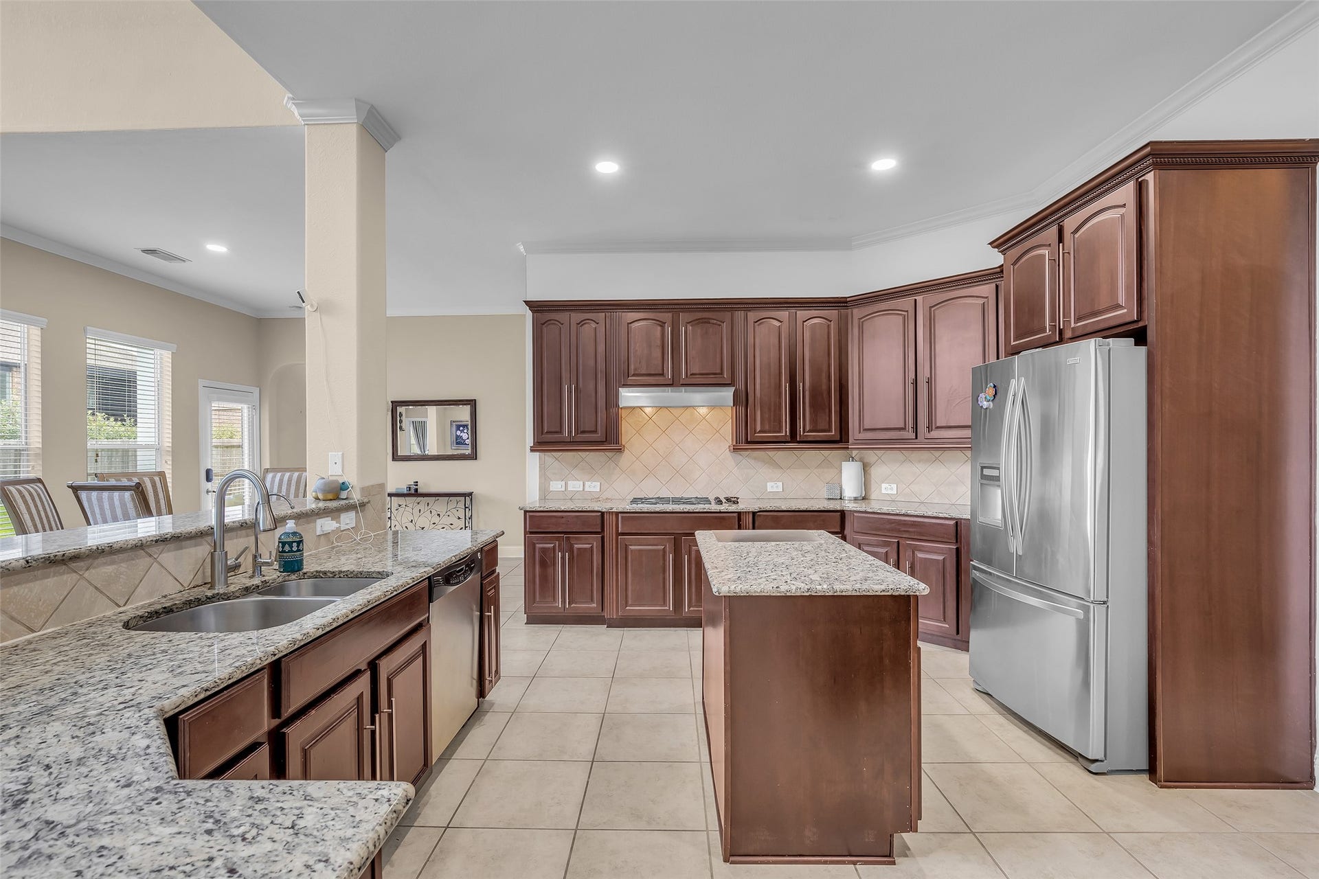 3314 Sussex Way, Friendswood, TX 77546 The kitchen features elegant rich brown cabinets that add warmth and character to the space.