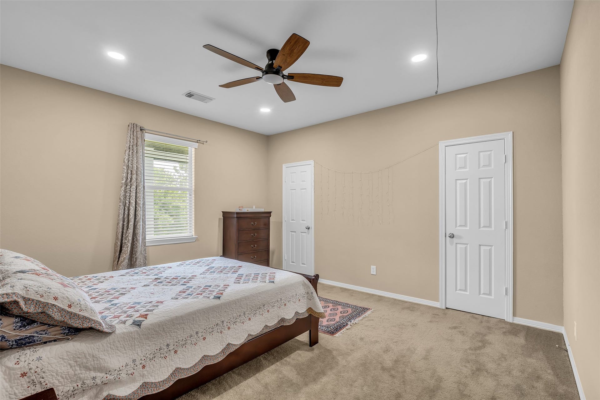 3314 Sussex Way, Friendswood, TX 77546 Secondary bedroom on the second floor featuring a walk-in closet and a window overlooking the backyard.