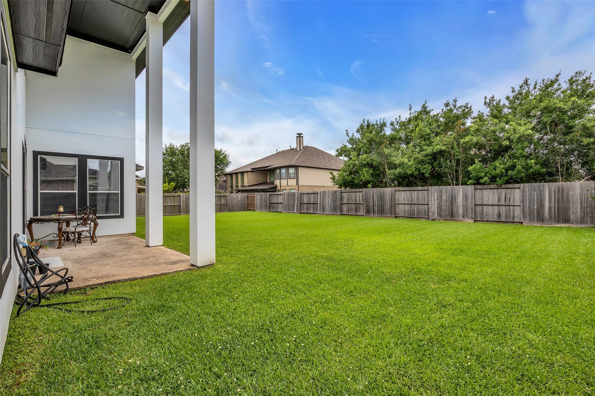 3314 Sussex Way, Friendswood, TX 77546 At the back of the home is a small patio overlooking the entire backyard, providing a pleasant outdoor space to relax and enjoy the view.