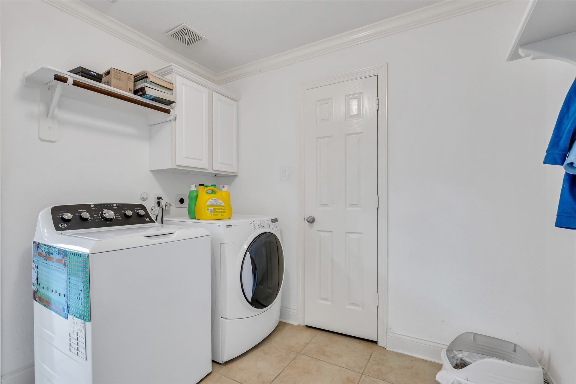 3314 Sussex Way, Friendswood, TX 77546 Laundry room conveniently located beside the staircase off the kitchen, designed for easy access and everyday use.