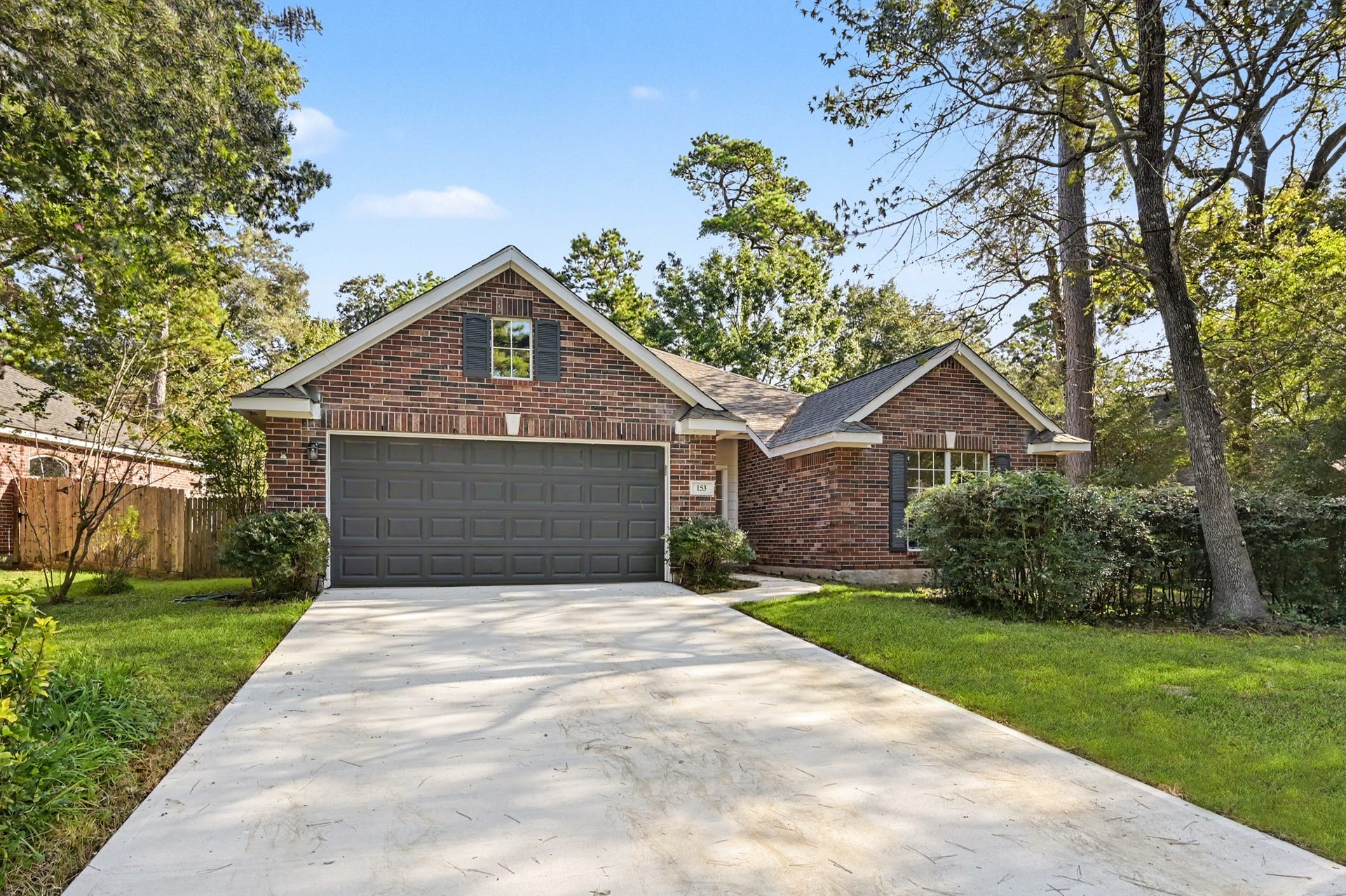Charming brick home with a spacious two-car garage, with mature trees in the Village of Alden Bridge, The Woodlands