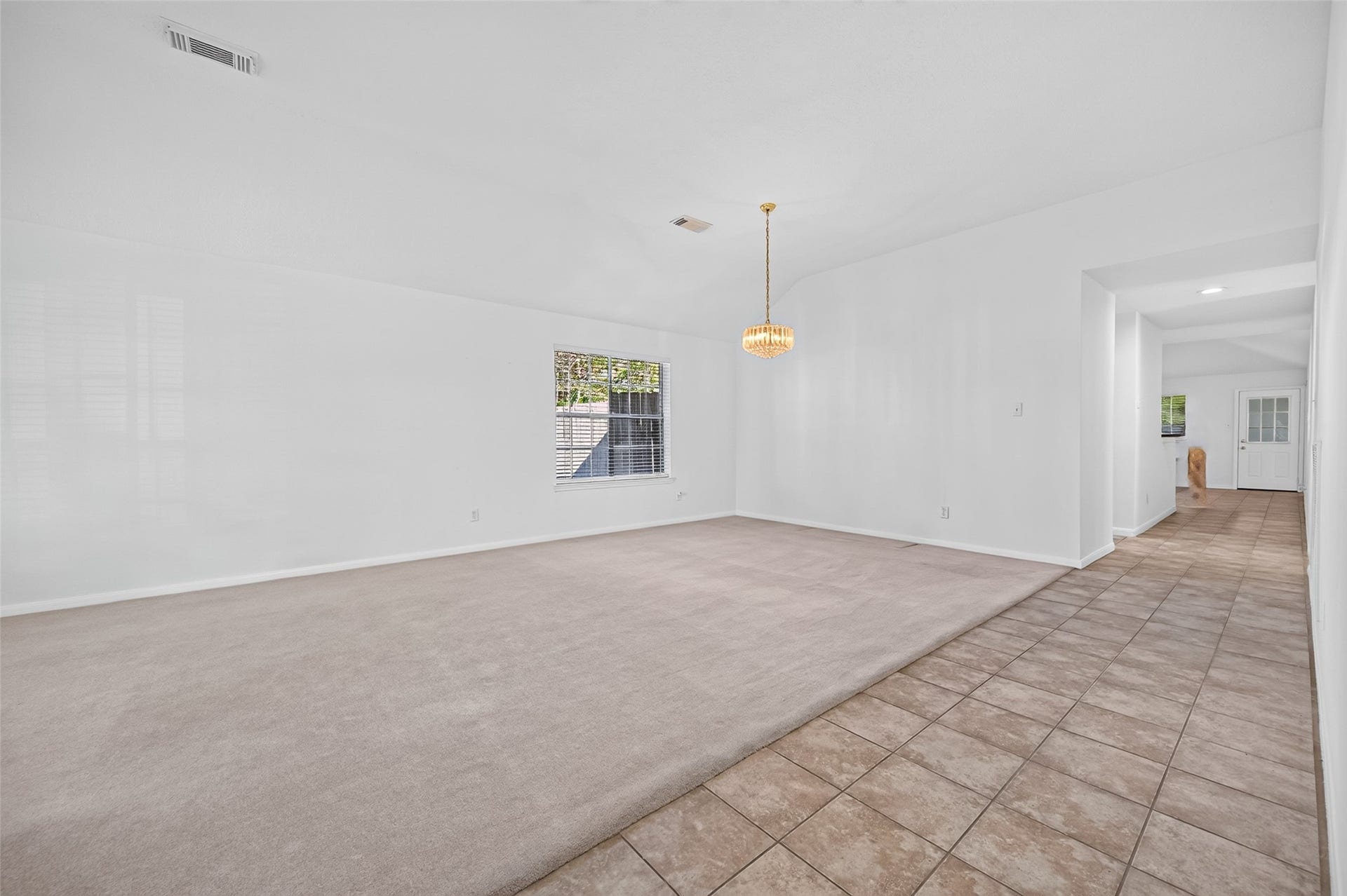 2703 Blue Mist Drive, Sugar Land, TX 77498 Charming brick archway leads to an inviting front door, complemented by elegant tiled flooring and lush greenery, offering a warm welcome.
