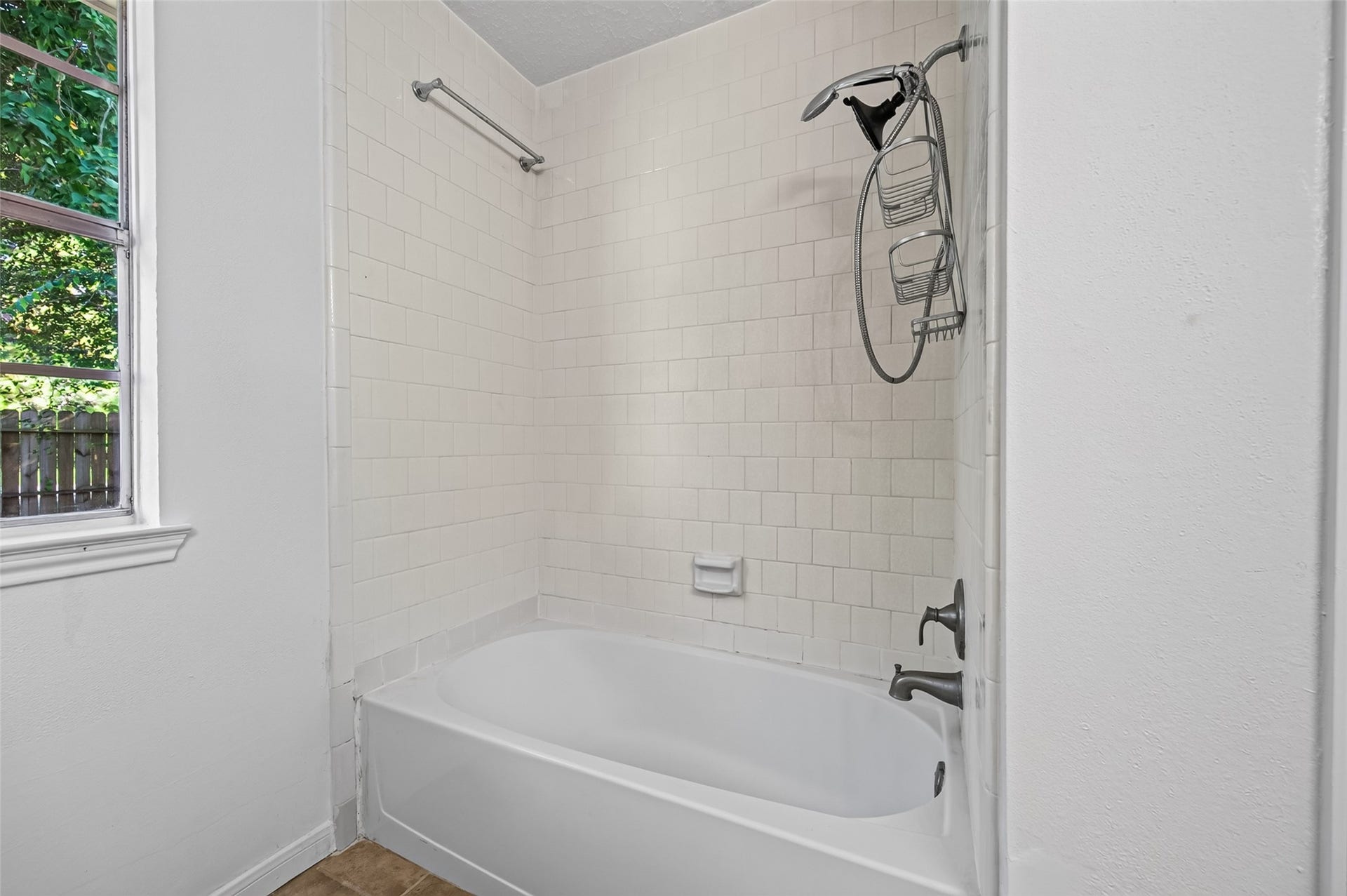 2703 Blue Mist Drive, Sugar Land, TX 77498 Spacious bathroom featuring a classic bathtub with shower, dual sinks, ample cabinet storage, and neutral tile flooring.