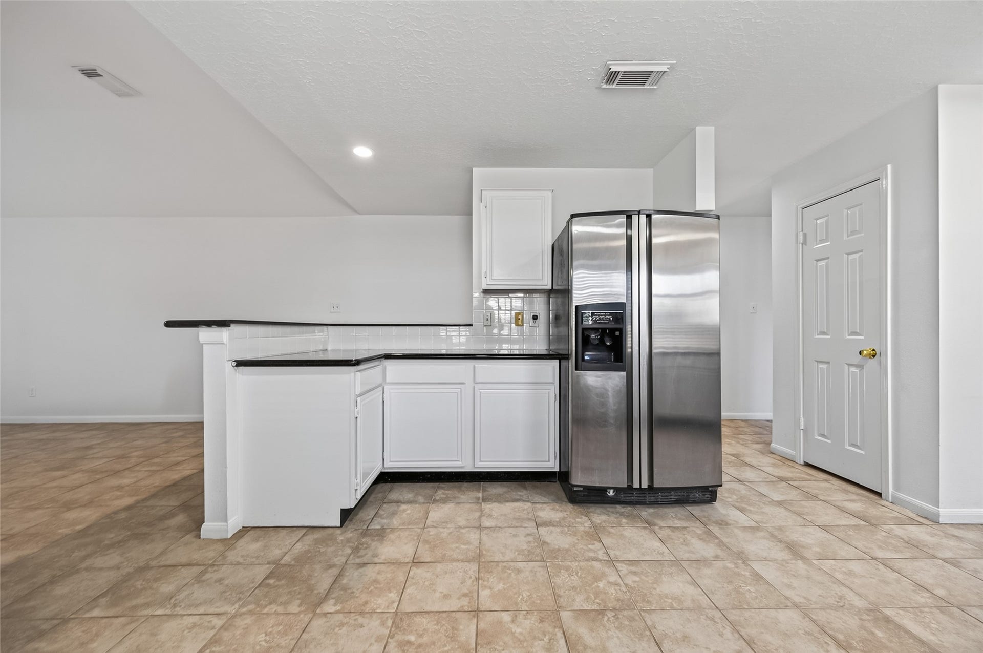 2703 Blue Mist Drive, Sugar Land, TX 77498 Bright kitchen featuring sleek black appliances, crisp white cabinetry, and a cozy bay window for natural light.