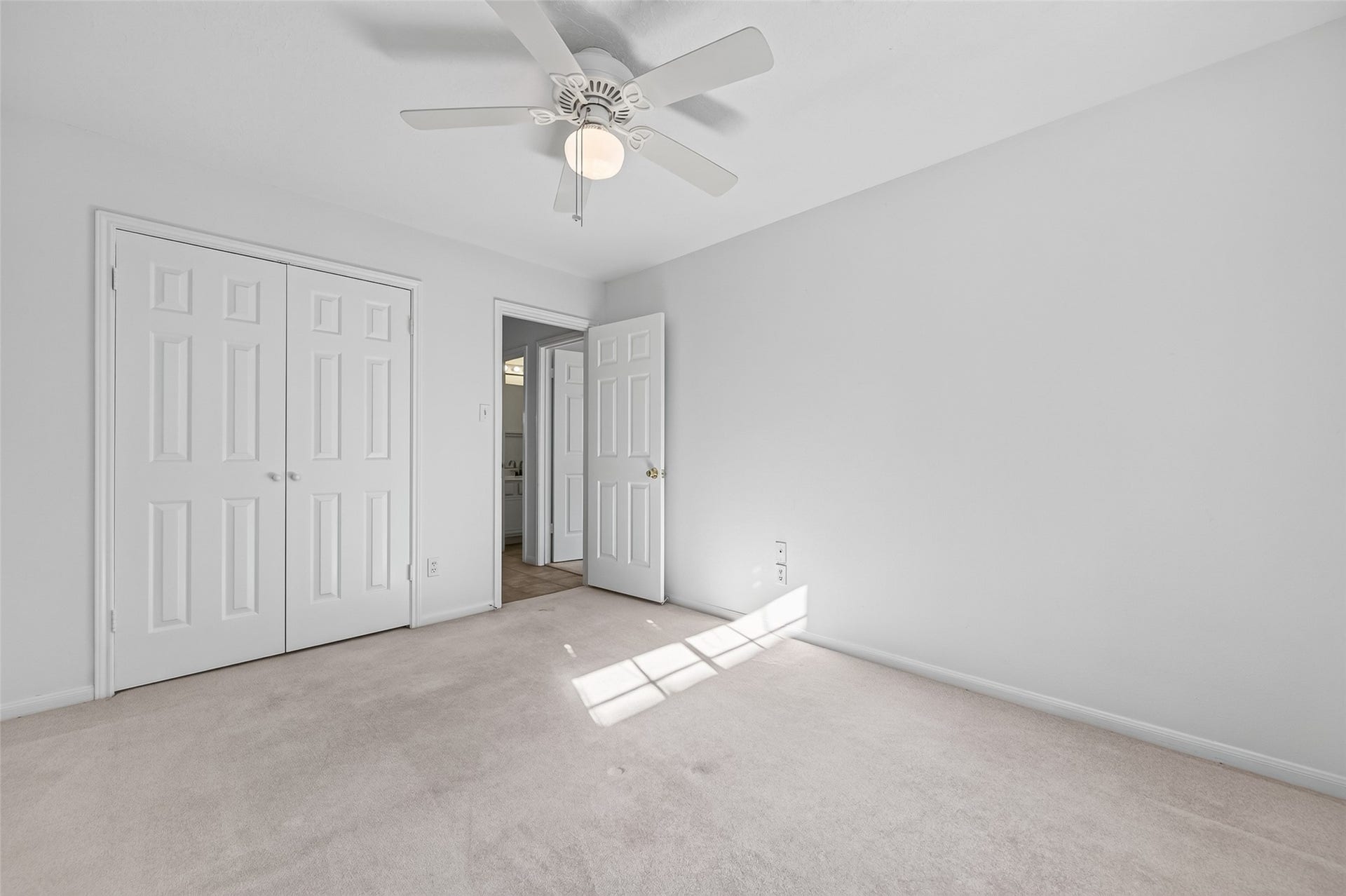 2703 Blue Mist Drive, Sugar Land, TX 77498 Bright and airy bedroom featuring a ceiling fan and a large window, offering plenty of natural light and a cozy atmosphere.