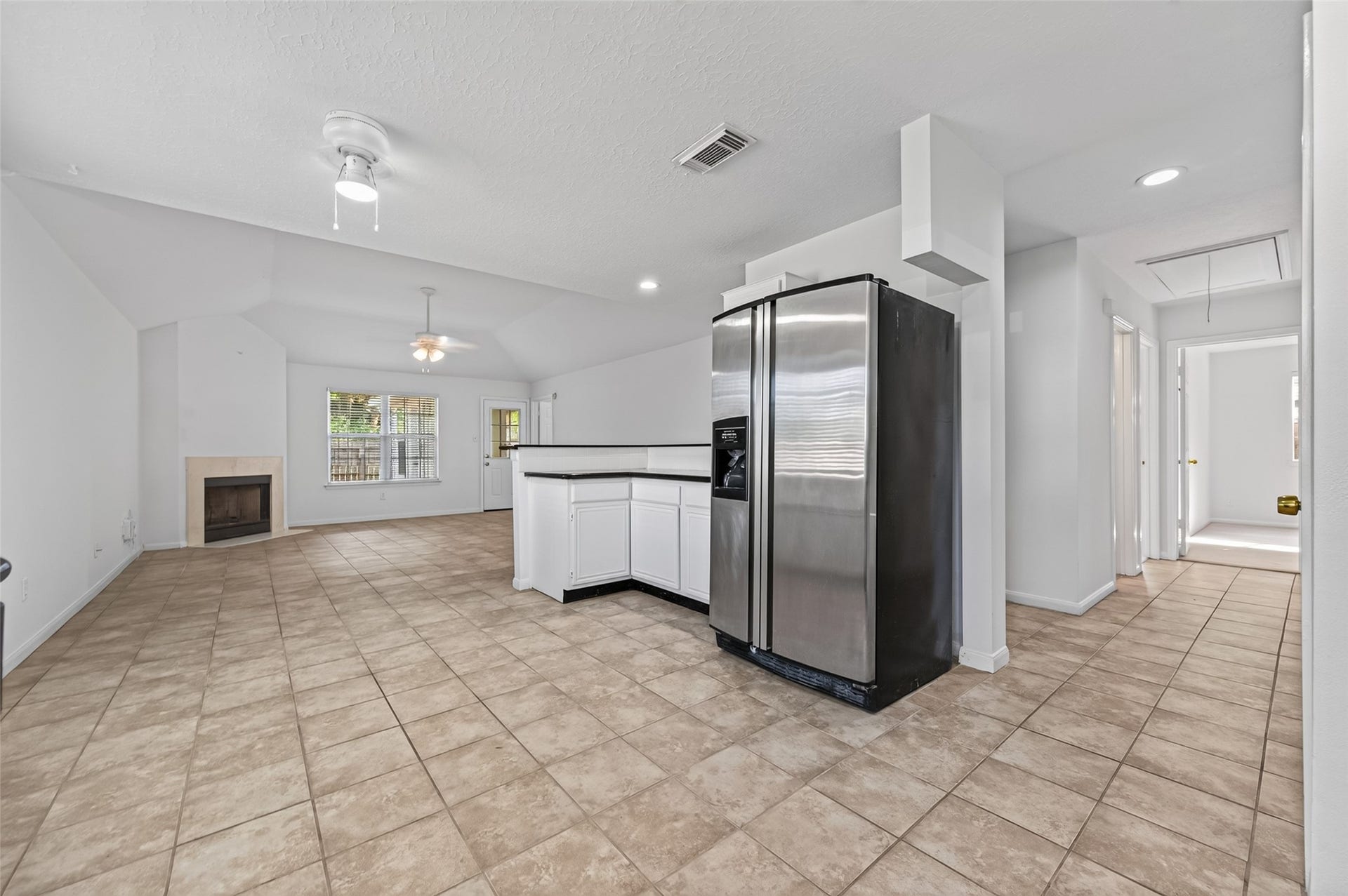 2703 Blue Mist Drive, Sugar Land, TX 77498 Bright and inviting kitchen with sleek black appliances, white cabinetry, and ample counter space, perfect for culinary adventures.