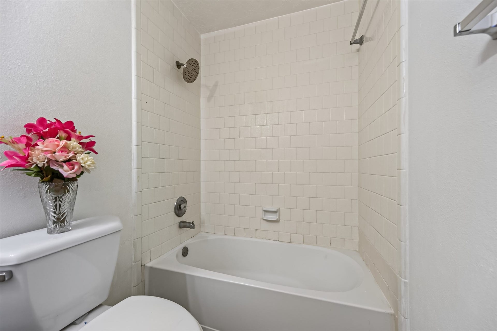 2703 Blue Mist Drive, Sugar Land, TX 77498 Bright and inviting bathroom featuring a spacious vanity, large mirror, and a classic white tiled shower-tub combination.