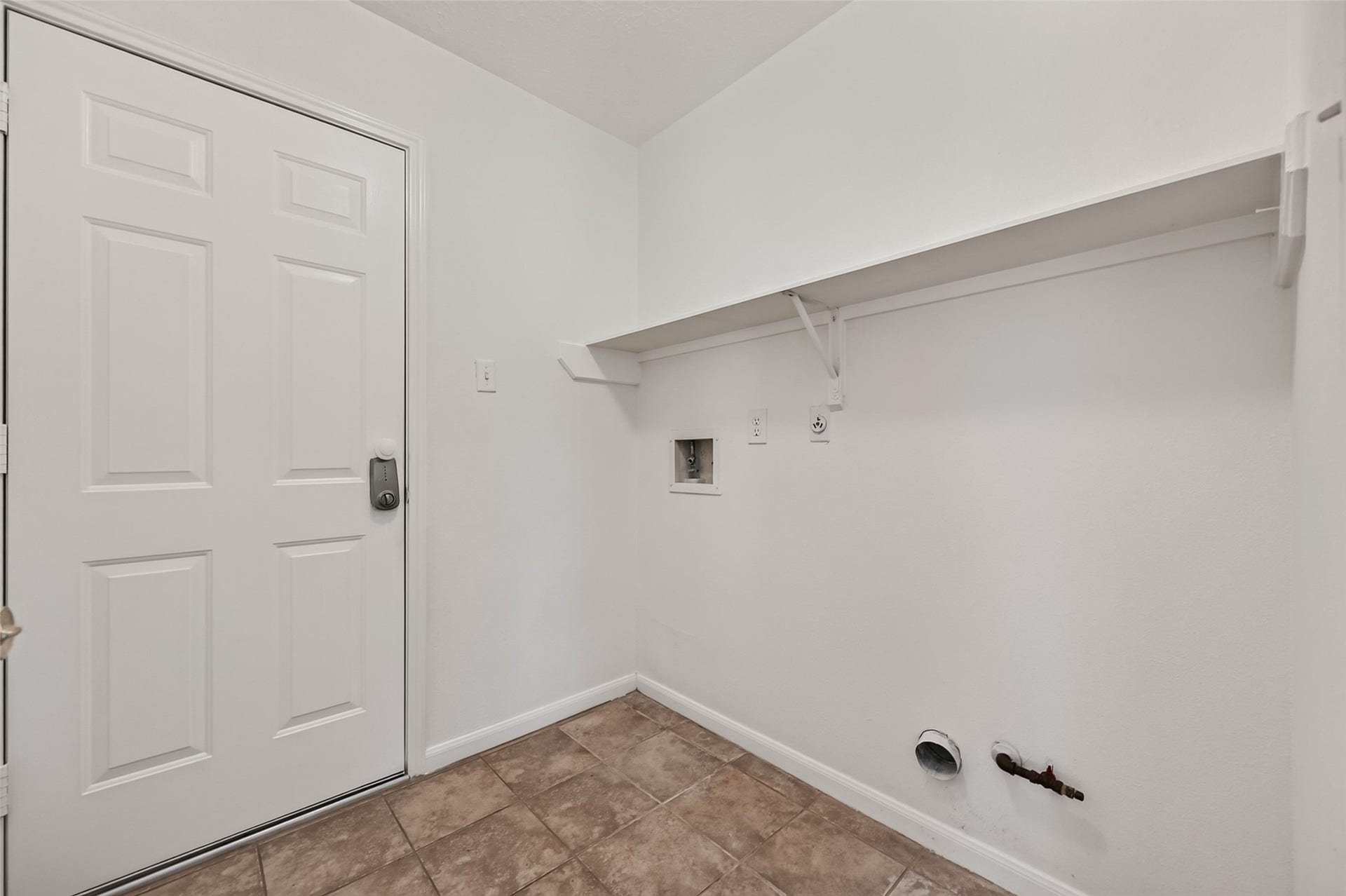 2703 Blue Mist Drive, Sugar Land, TX 77498 Spacious living room with tiled flooring, a cozy fireplace, and abundant natural light from a large window, offering a warm and inviting atmosphere.