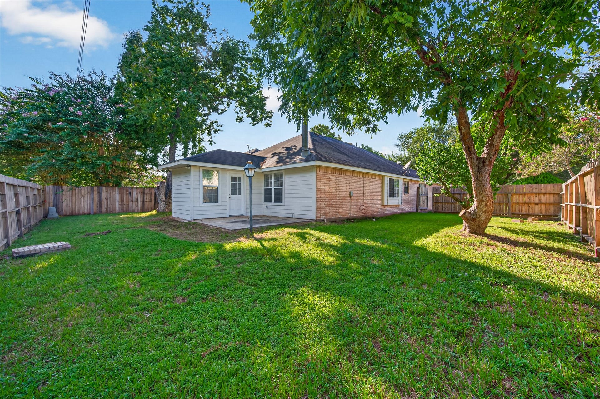 2703 Blue Mist Drive, Sugar Land, TX 77498 Bright, airy room with tiled flooring, a large window for natural light, and a ceiling fan for comfort, offering access through a stylish glass-paneled door.