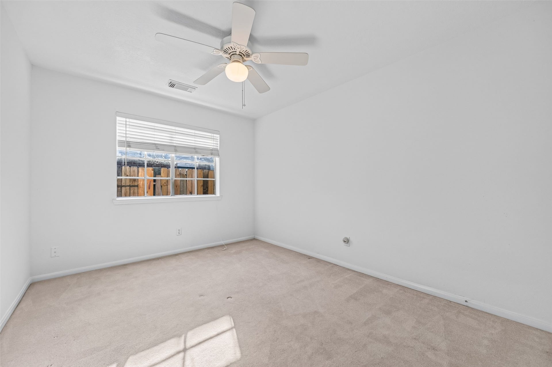 2703 Blue Mist Drive, Sugar Land, TX 77498 Spacious open-concept living area with tiled floors and a modern kitchen featuring white cabinetry and stainless steel appliances, perfect for entertaining.