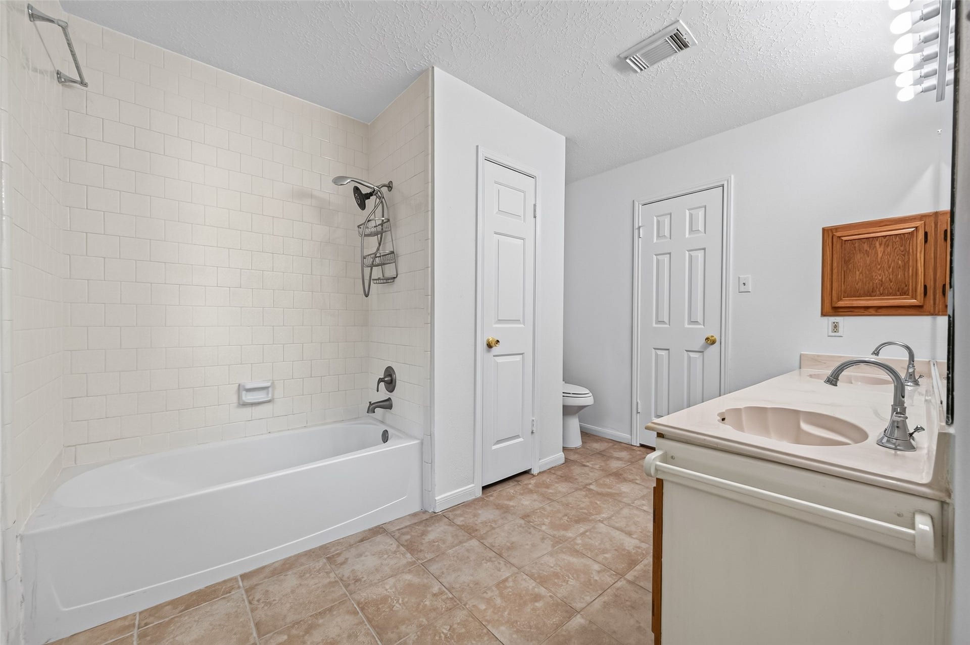 2703 Blue Mist Drive, Sugar Land, TX 77498 Spacious carpeted room with a ceiling fan, leading to a cozy tiled area with a fireplace.