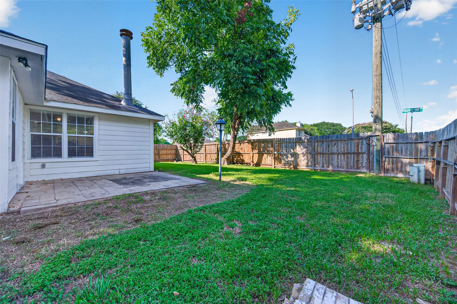 2703 Blue Mist Drive, Sugar Land, TX 77498 Bright sunroom with tiled flooring, ample natural light, and a convenient wall-mounted air conditioner, ideal for relaxation or a home office.