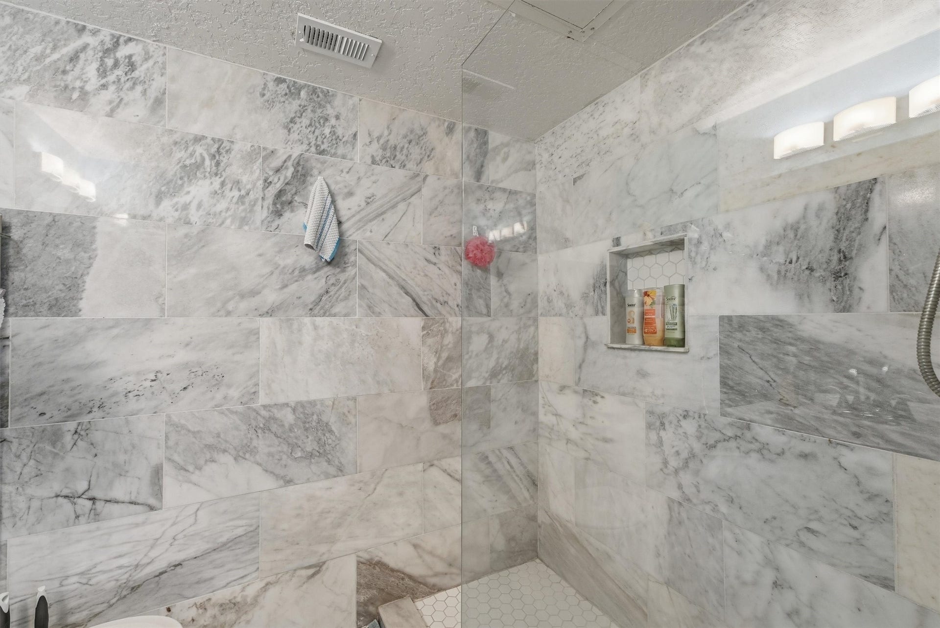 6300 Seawall Boulevard, #9321, Galveston, TX 77551 Walk-in shower finished in marble-look tile